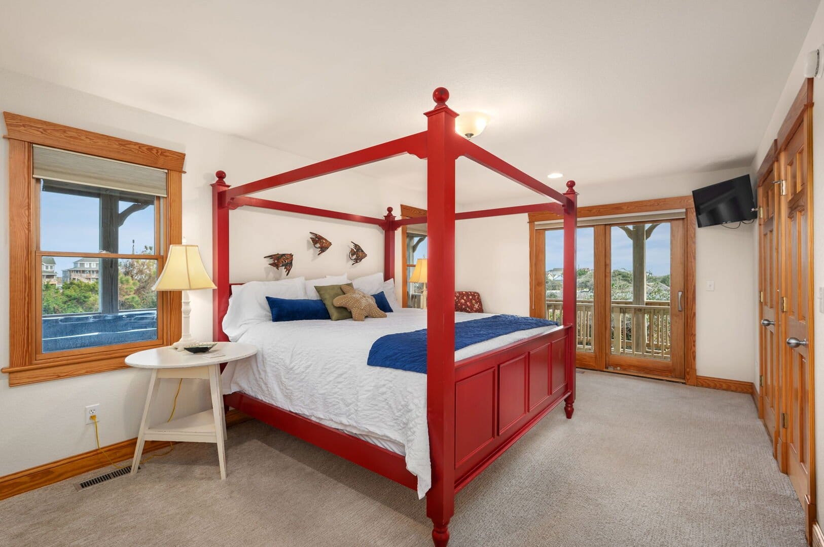 Red canopy bed, cozy bedroom decor.