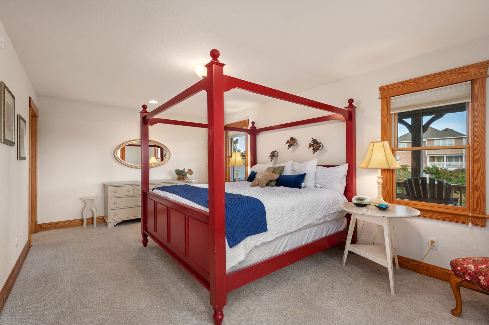 Red four-poster bed, cozy bedroom.