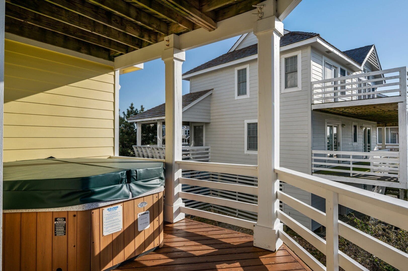 Hot tub on wooden deck, outdoors.