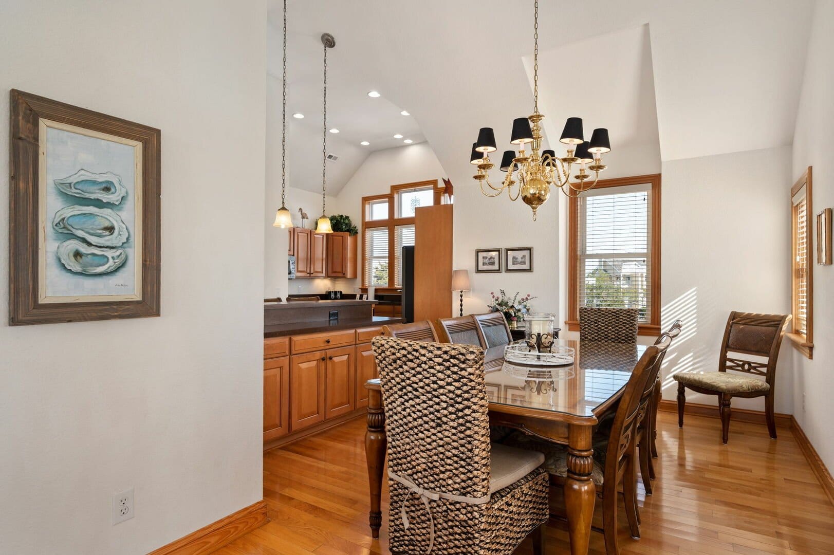 Dining room with chandelier and artwork.
