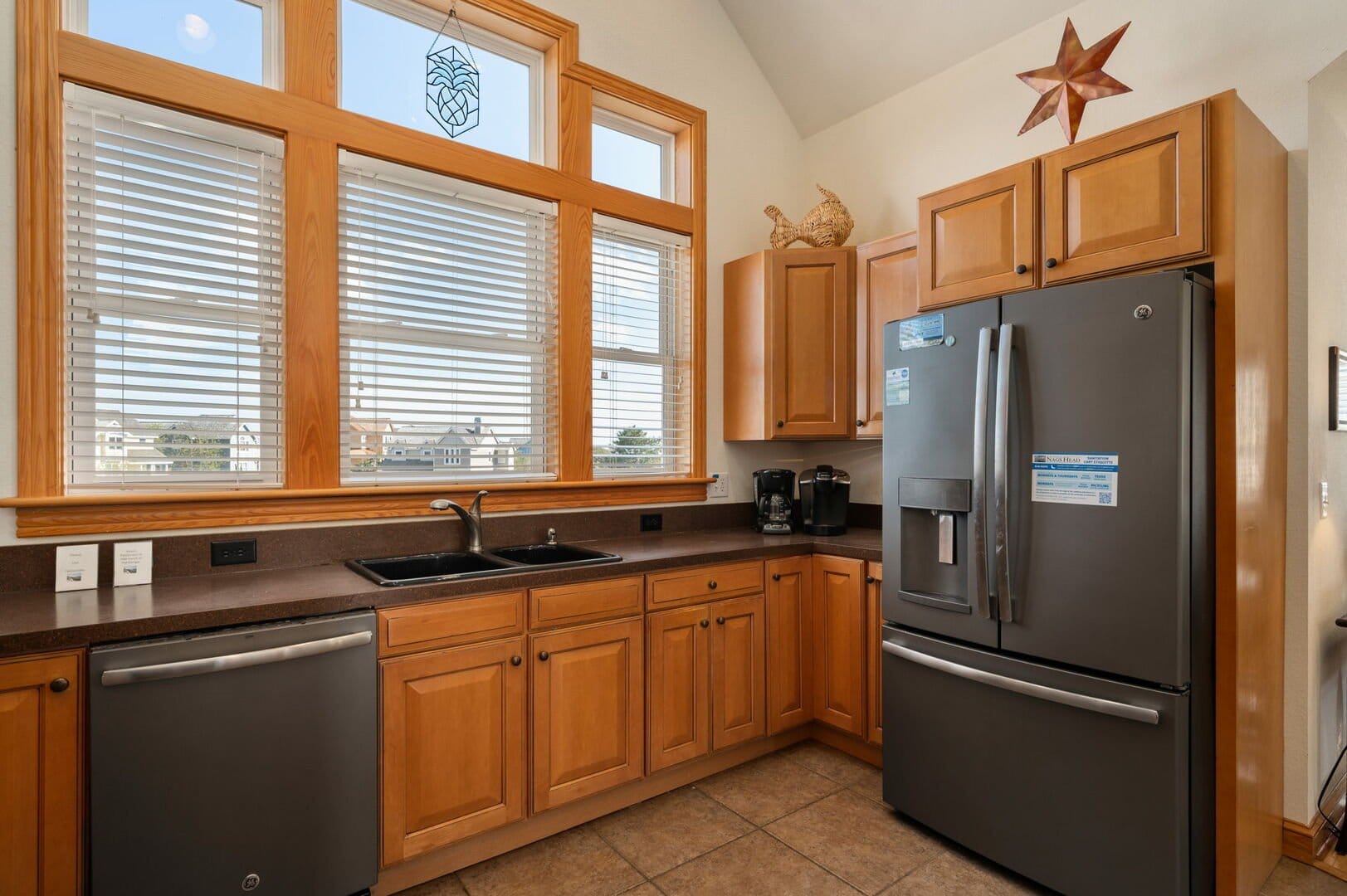 Kitchen with wooden cabinets, appliances.