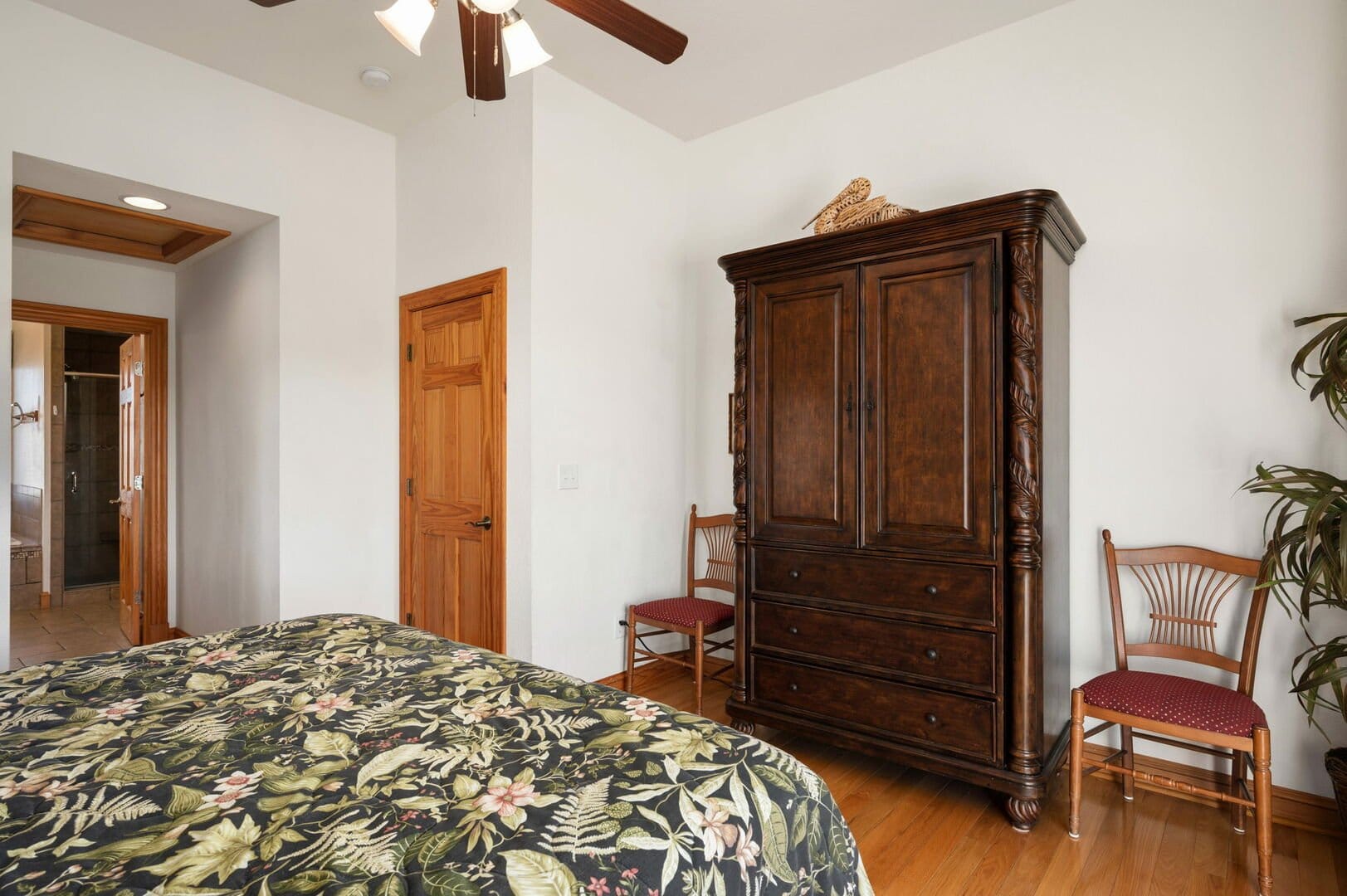 Bedroom with armoire and doorway.