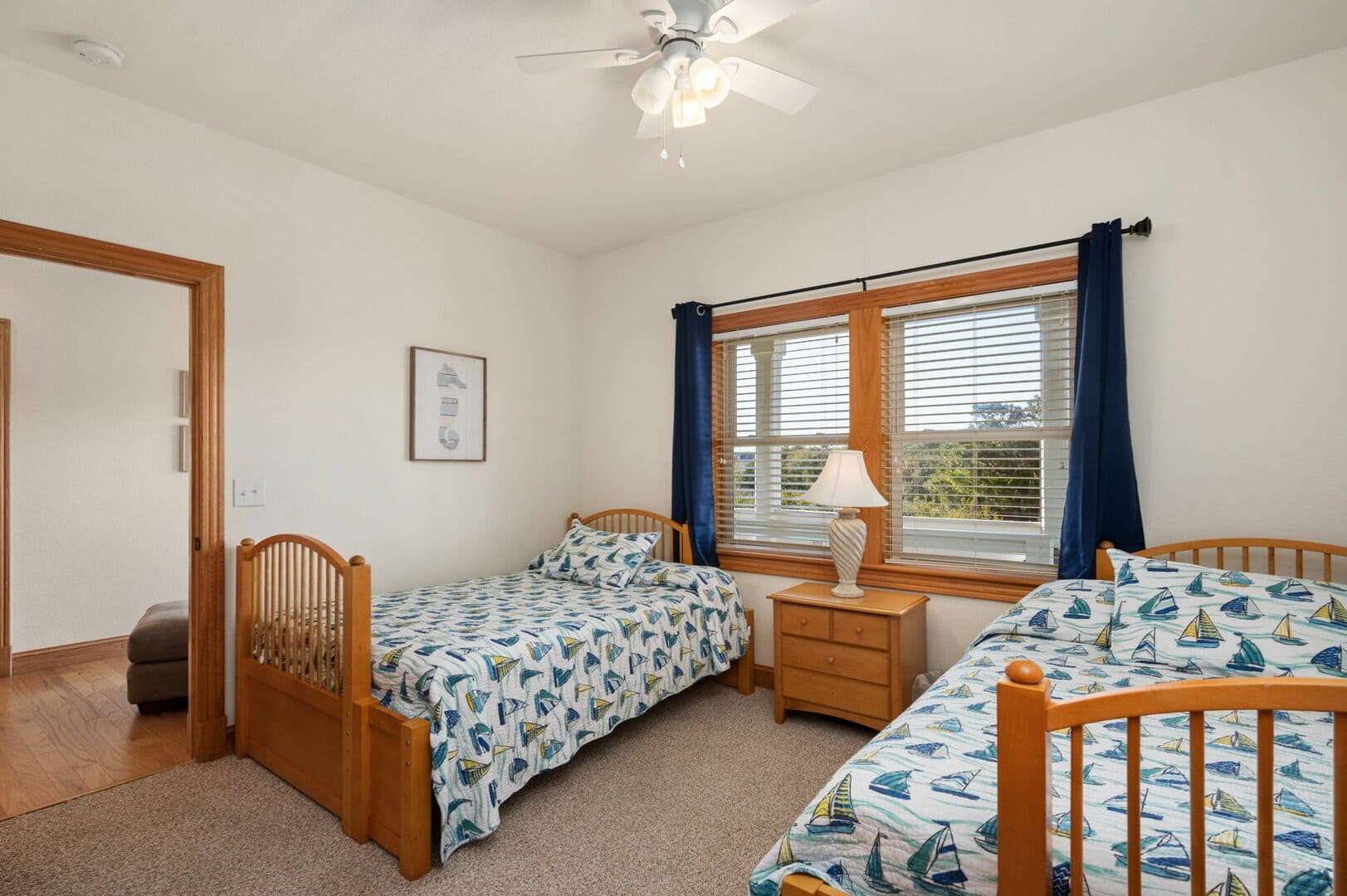 Two beds, nautical-themed bedroom.