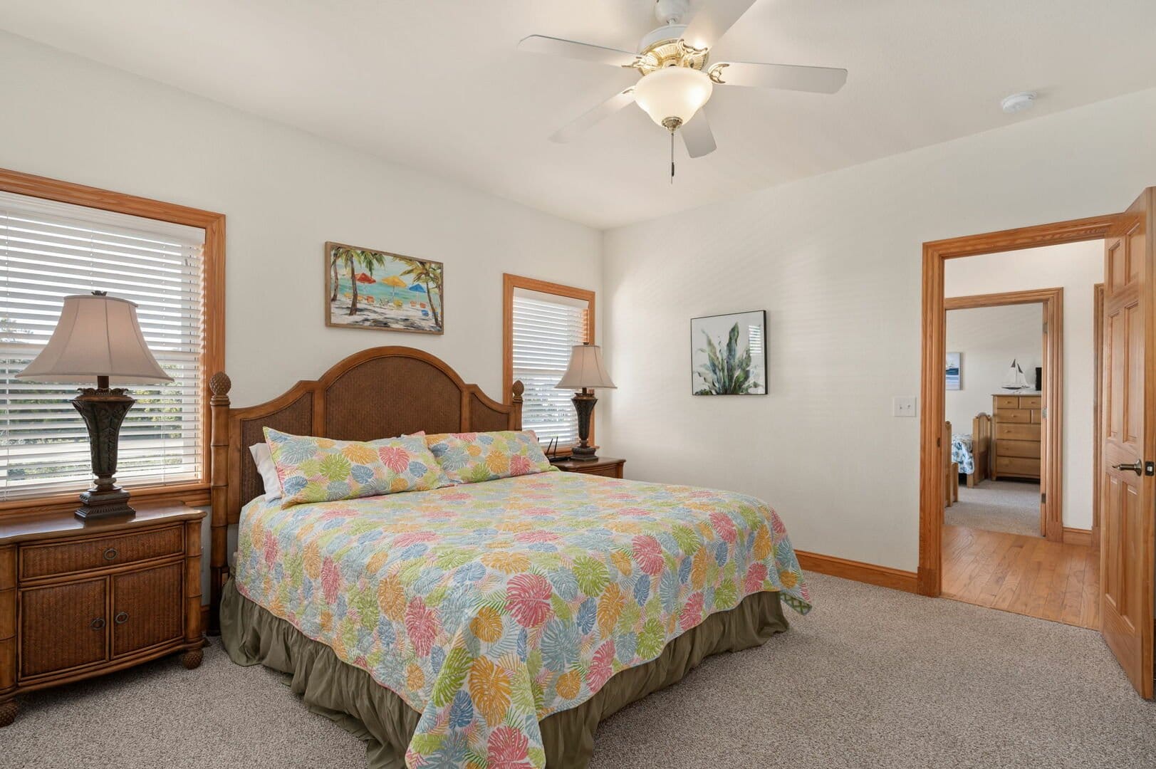 Bedroom with colorful bedspread.