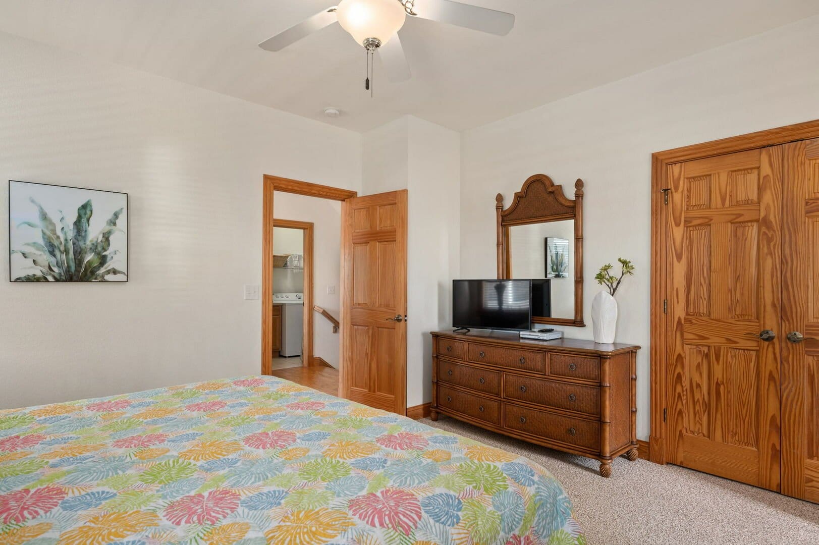 Bedroom with dresser and TV.