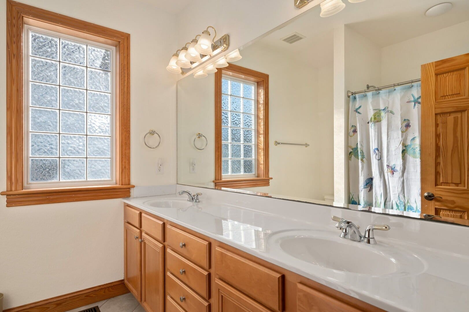 Bathroom with double sinks and shower.