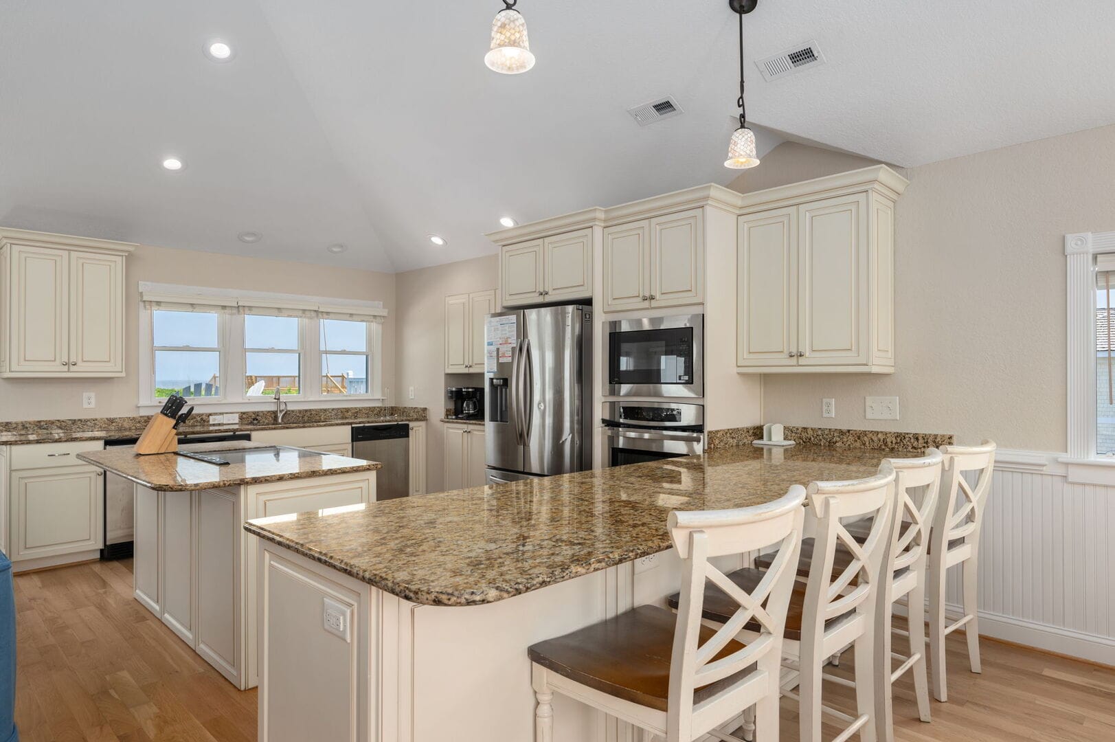 Spacious kitchen with granite countertops.