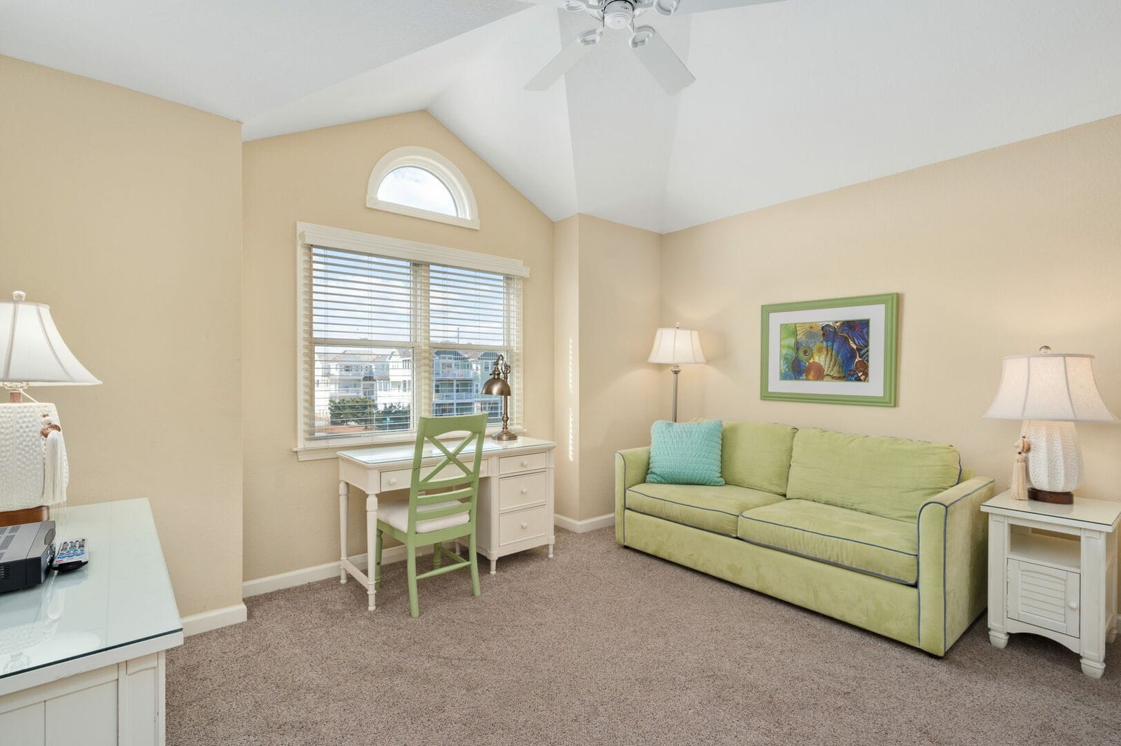 Cozy room with couch and desk.