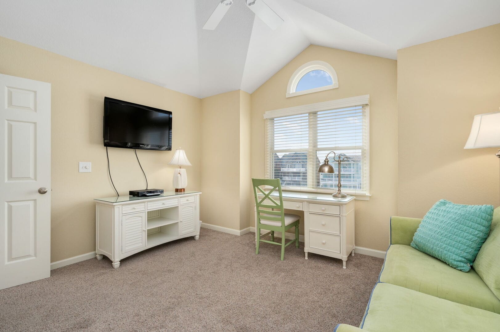 Cozy room with desk and television.