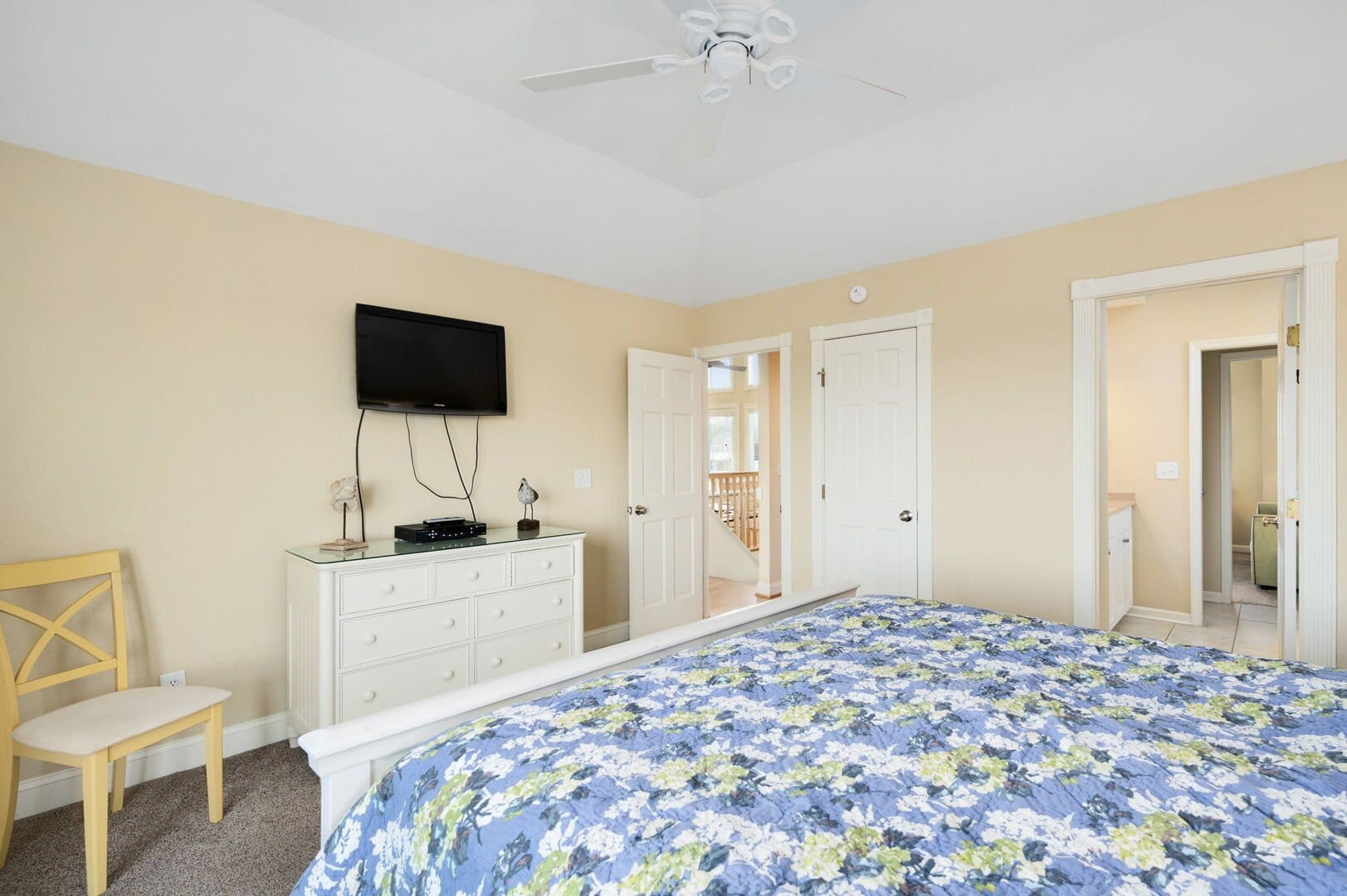 Bedroom with dresser and TV.
