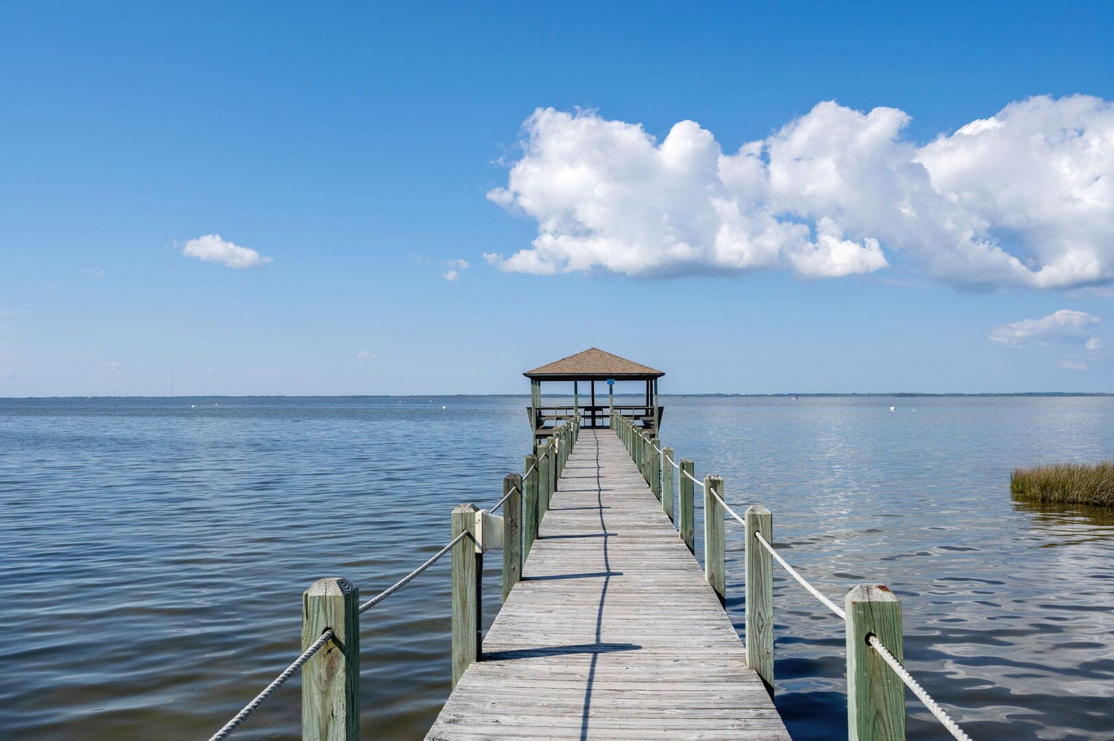 Dock leading to gazebo over water.