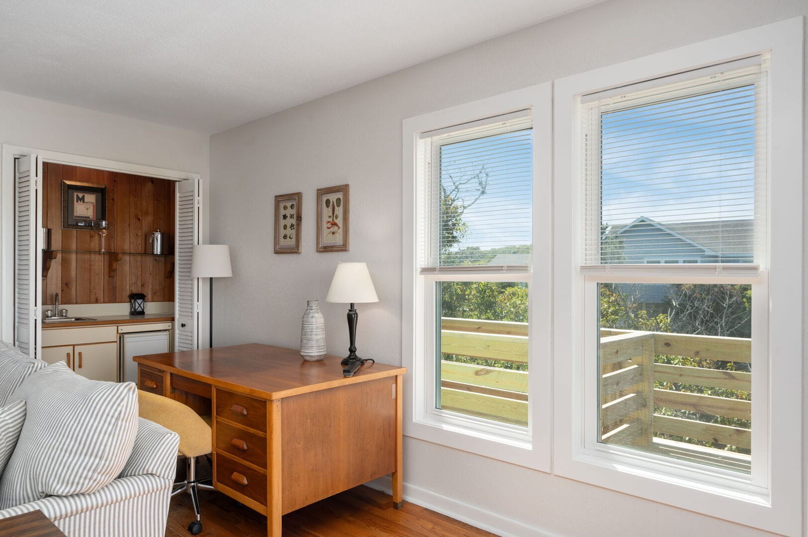 Home office with desk, windows.