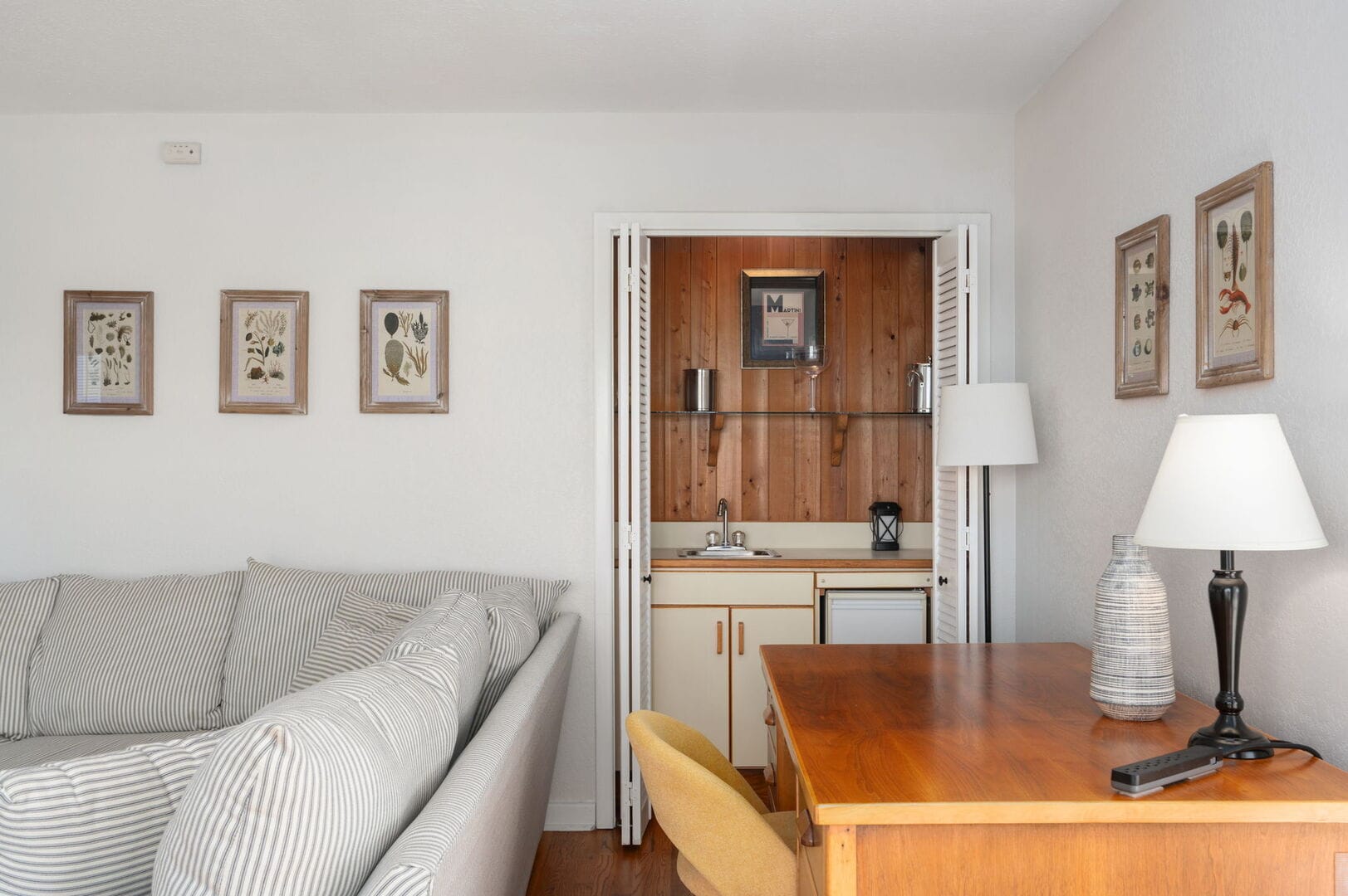 Cozy room with kitchenette and desk.