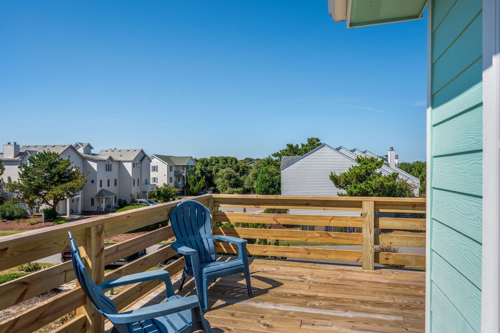 Deck chairs overlooking residential neighborhood.