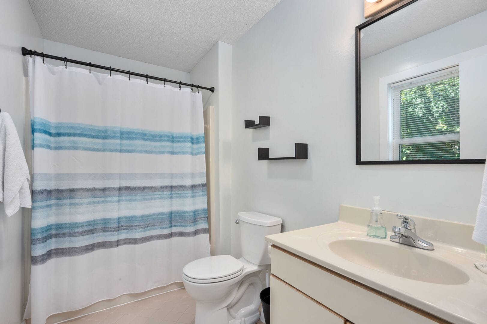 Modern white bathroom with blue accents.