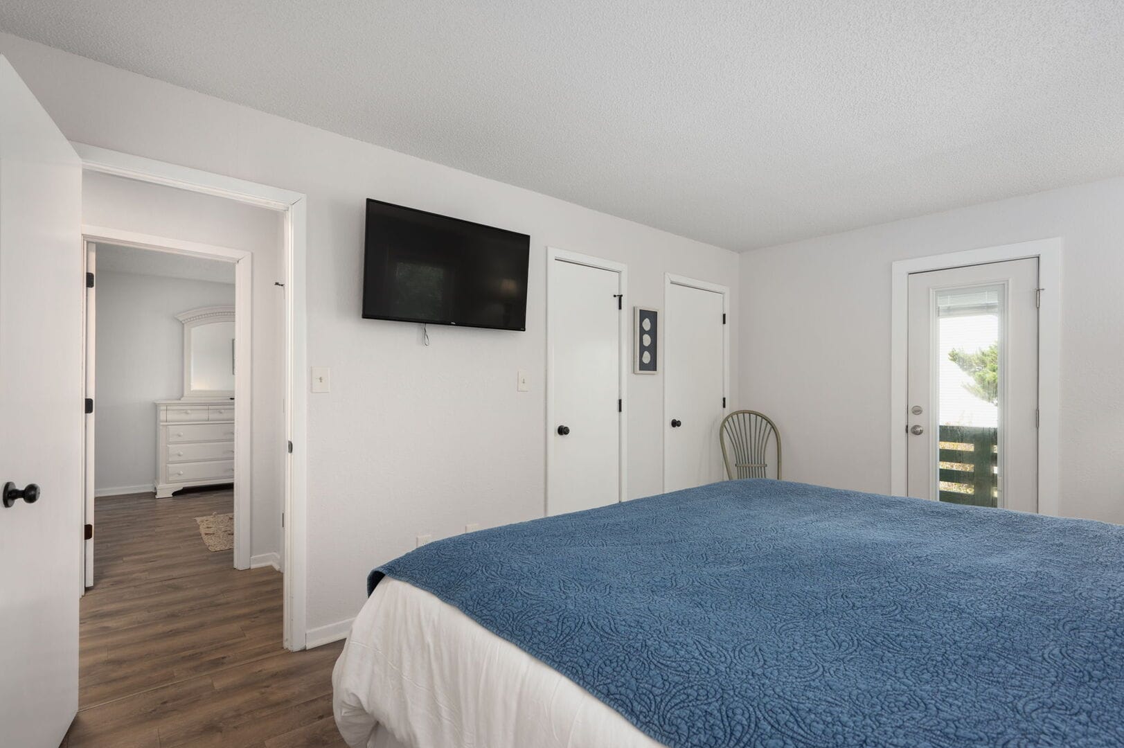 Bedroom with TV and doors.