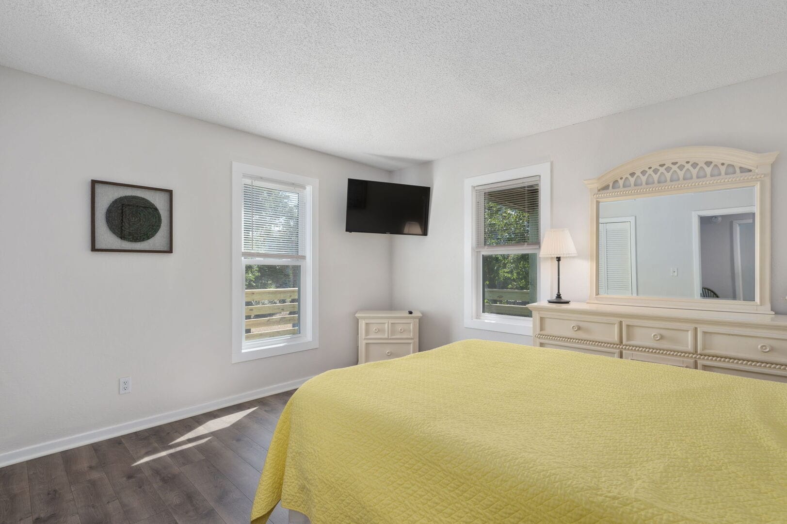 Bright bedroom with yellow bedspread.