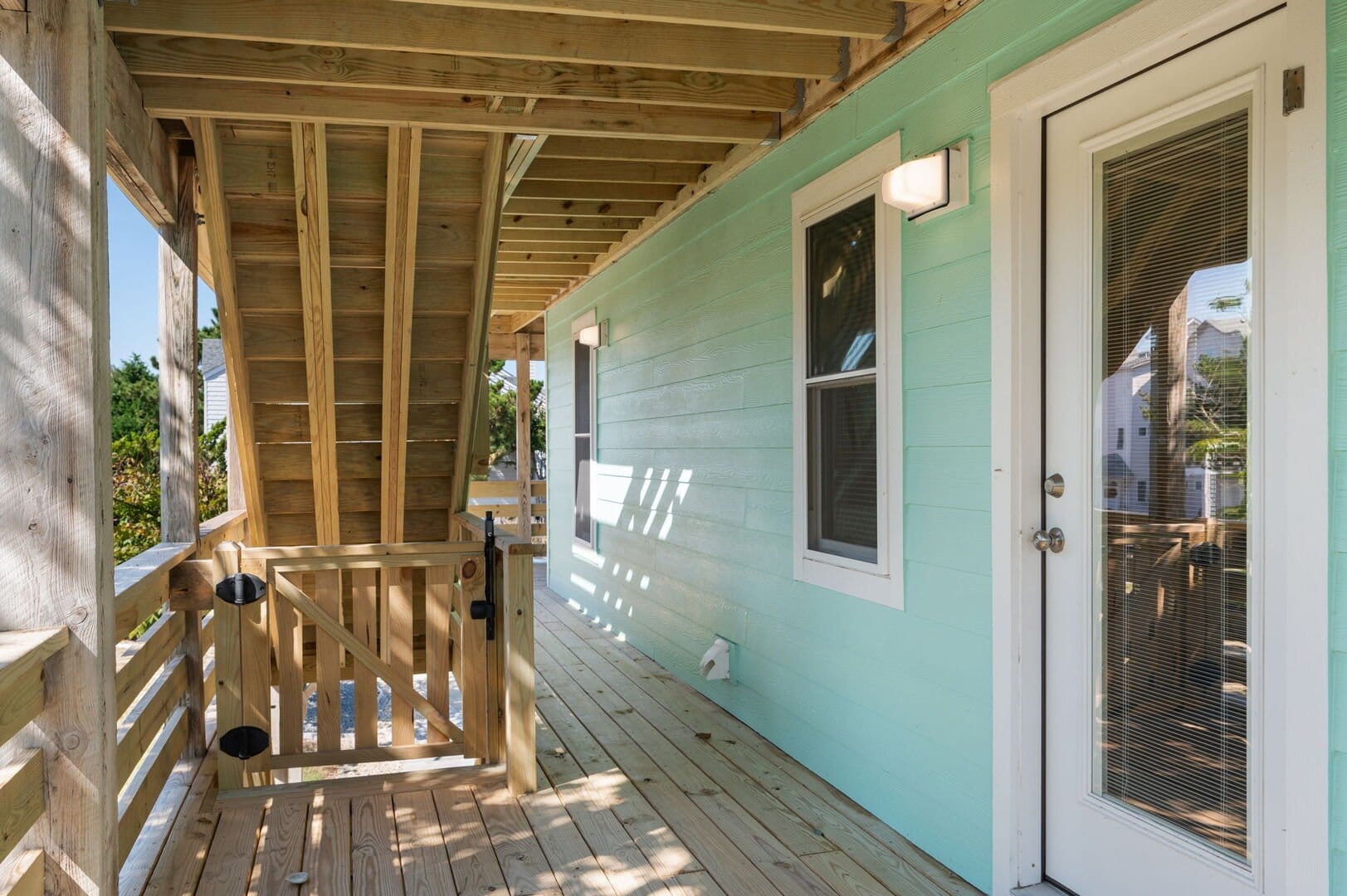 Wooden porch with mint wall.