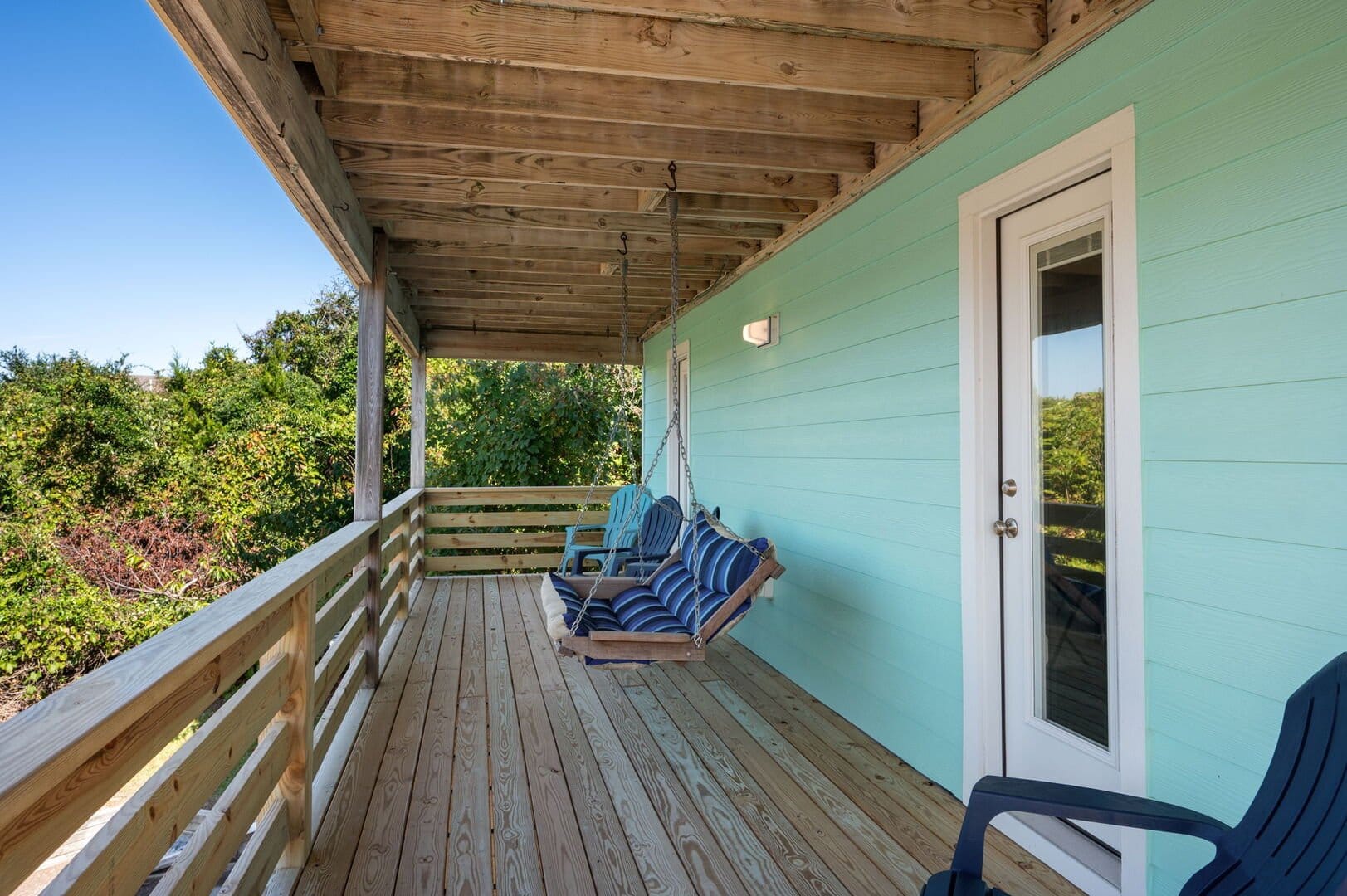 Wooden porch with swing bench.