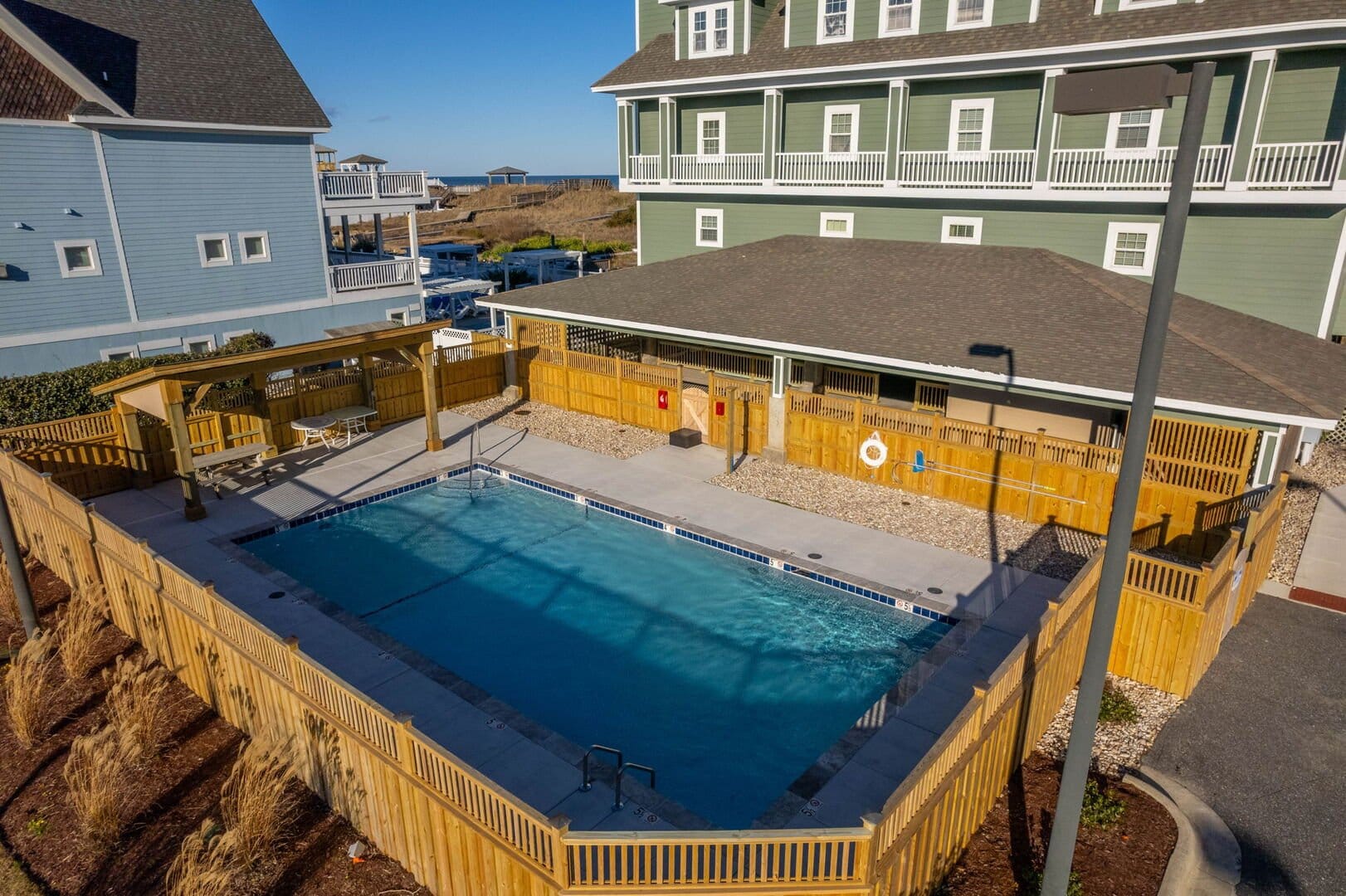Outdoor pool with surrounding houses.