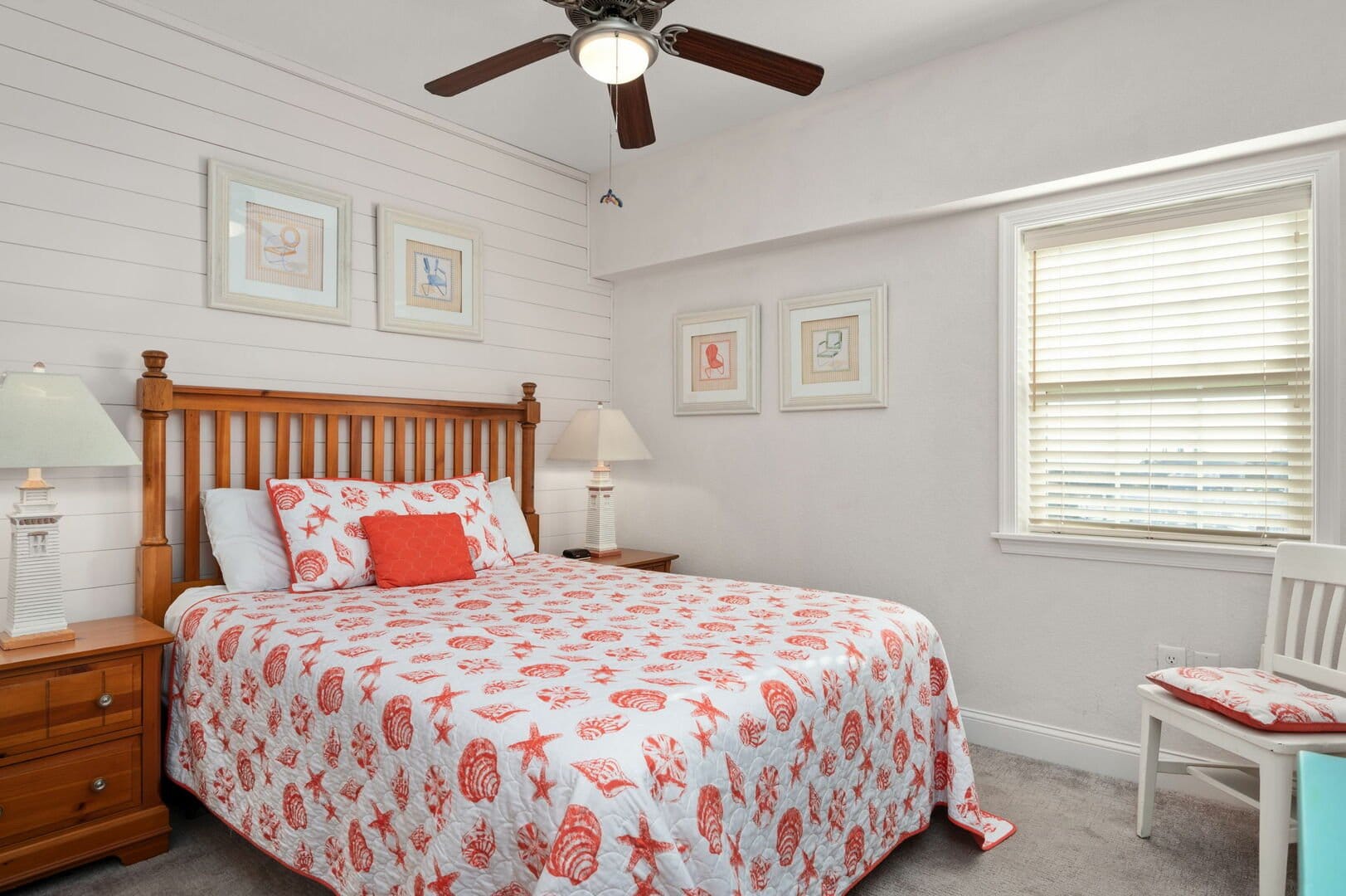 Coastal-themed bedroom with ceiling fan.