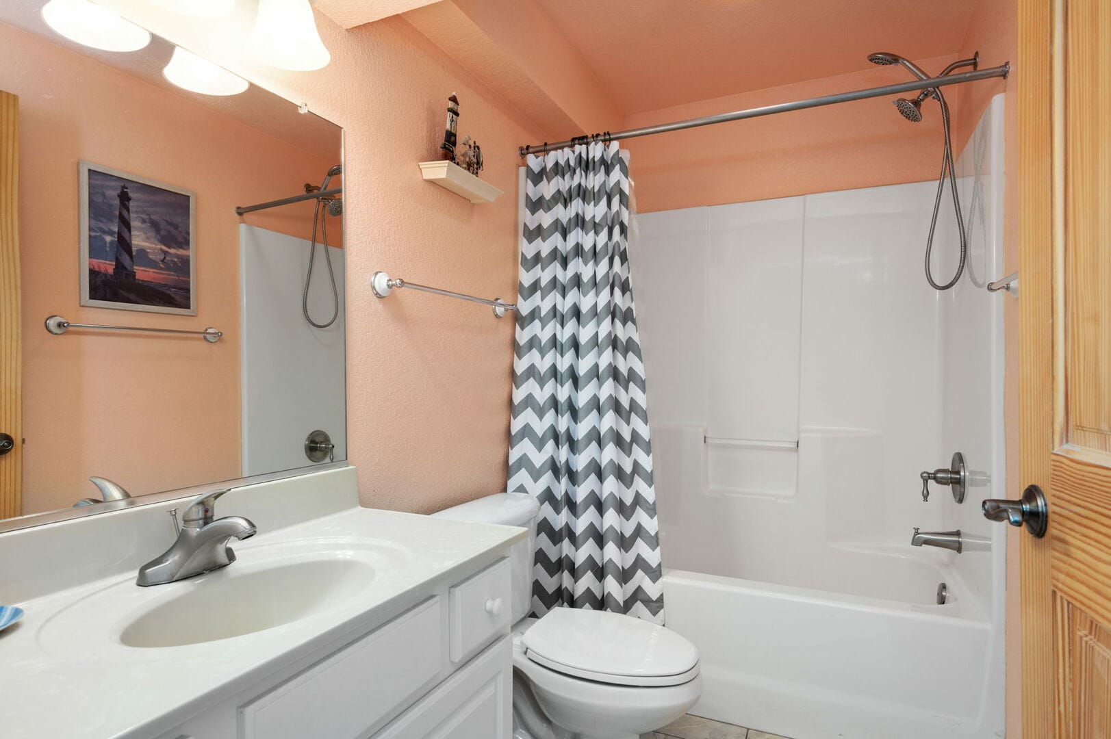 Bathroom with zigzag shower curtain.