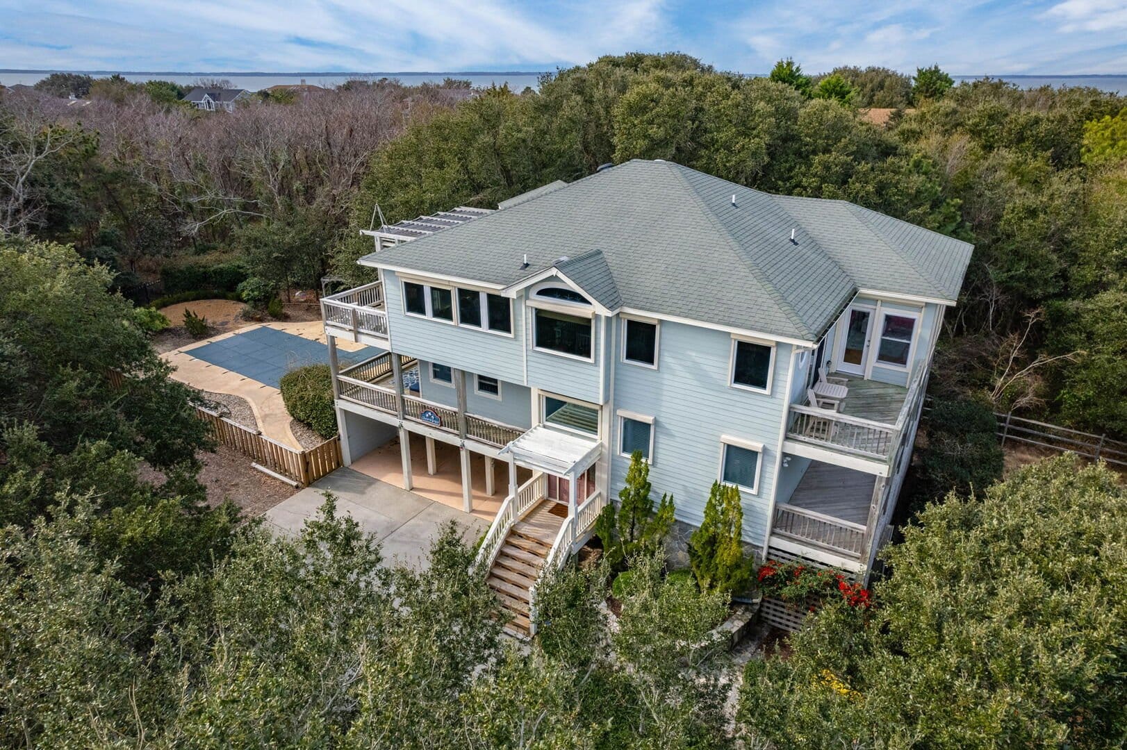 Large house surrounded by trees.