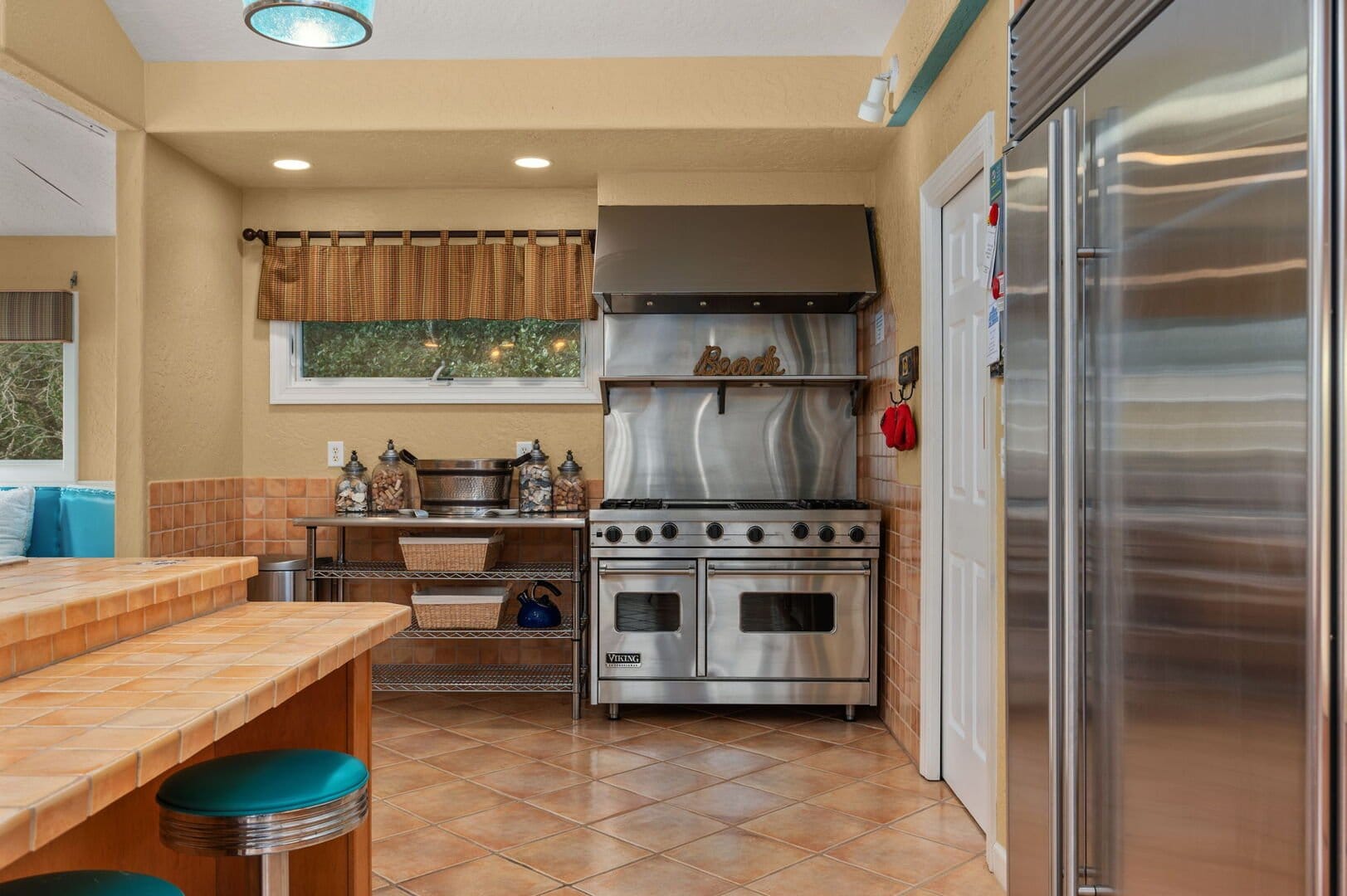 Stainless steel kitchen with stove.