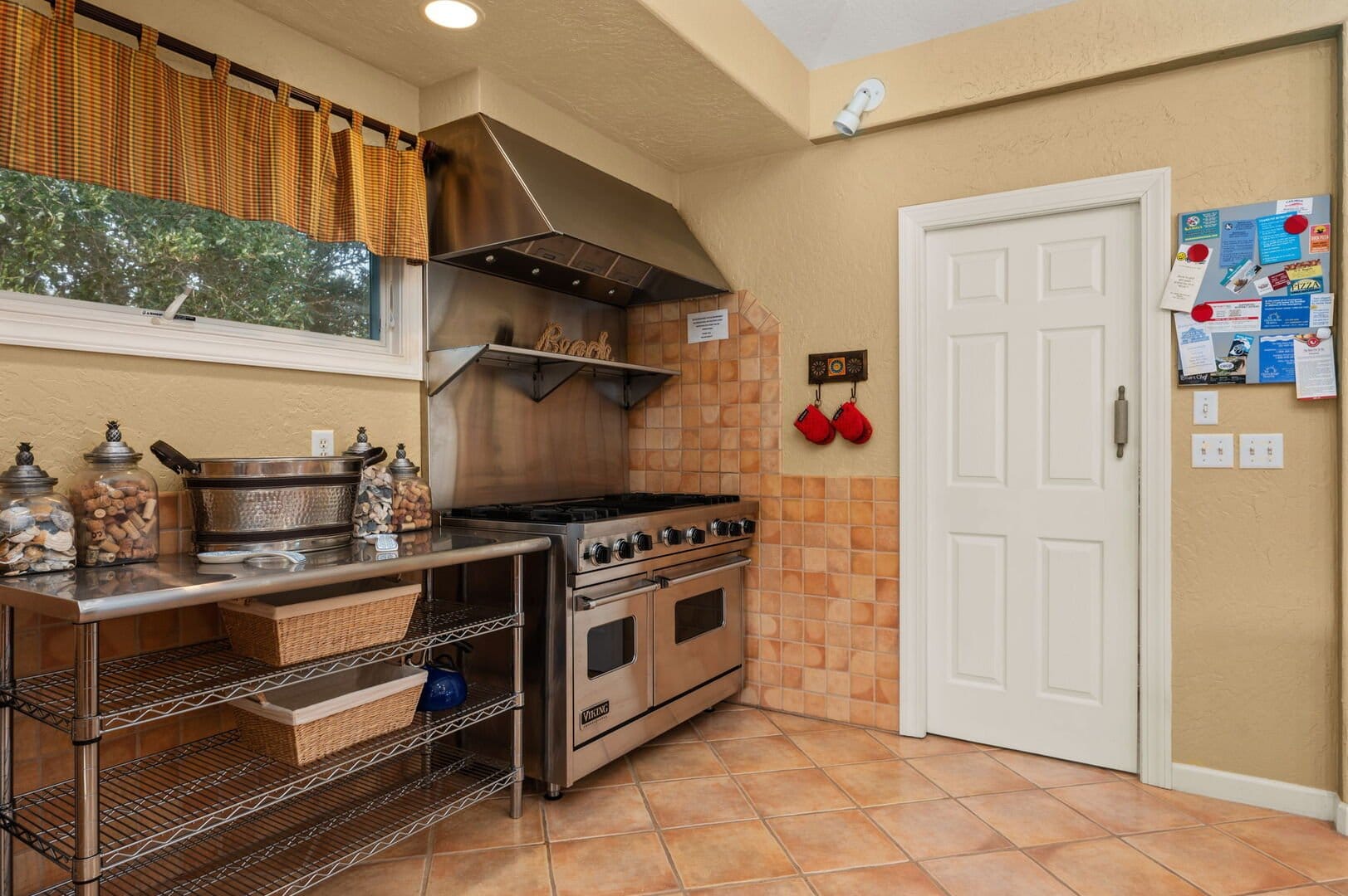 Kitchen with stove and storage shelves.