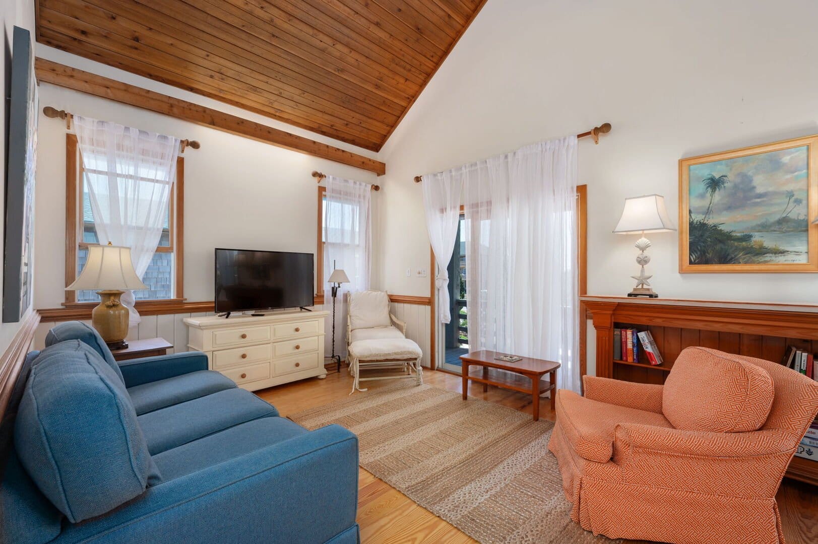 Cozy living room with wooden ceiling.