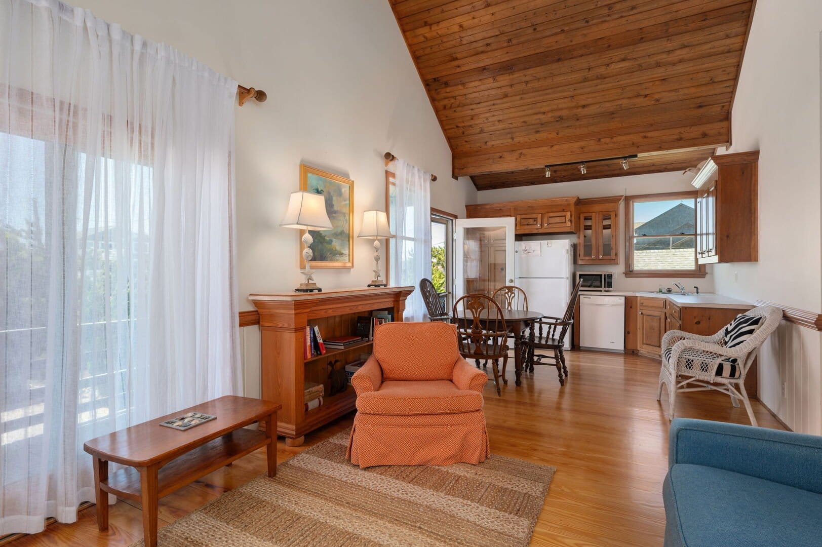 Cozy living room with wooden ceiling.