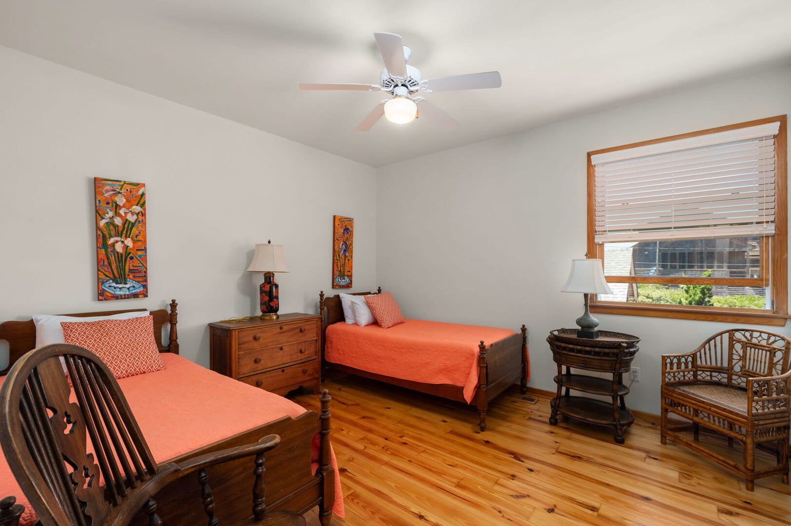 Two beds in a bright bedroom.
