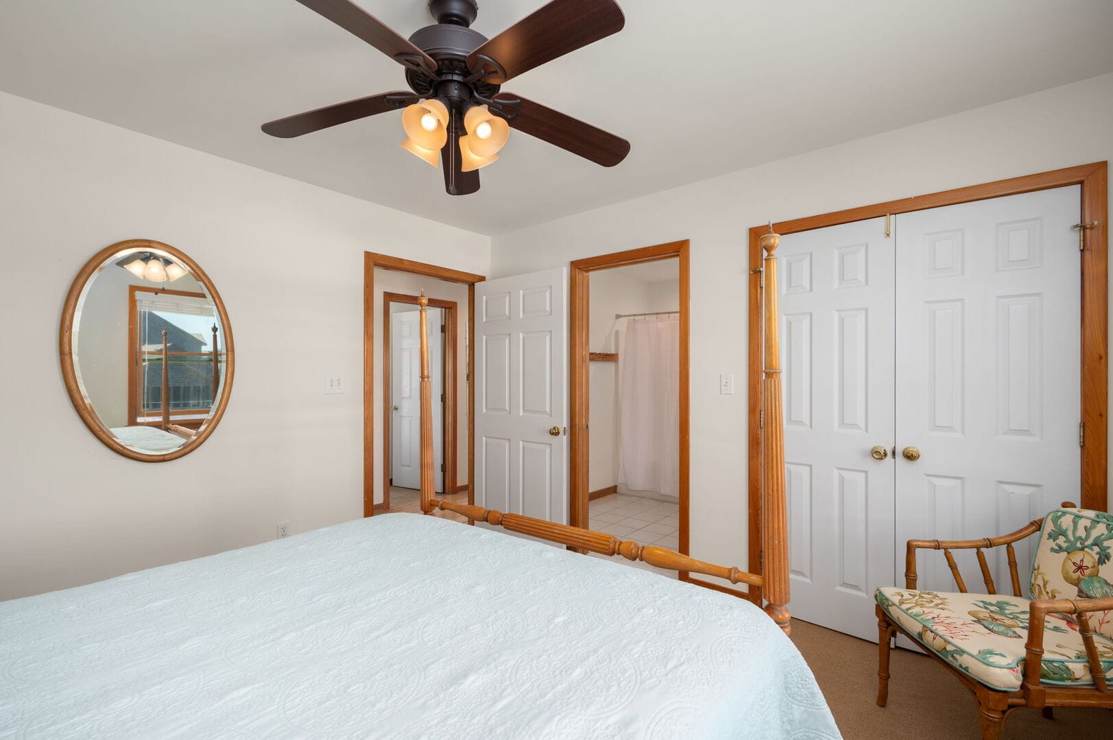 Bedroom with ceiling fan, mirror.