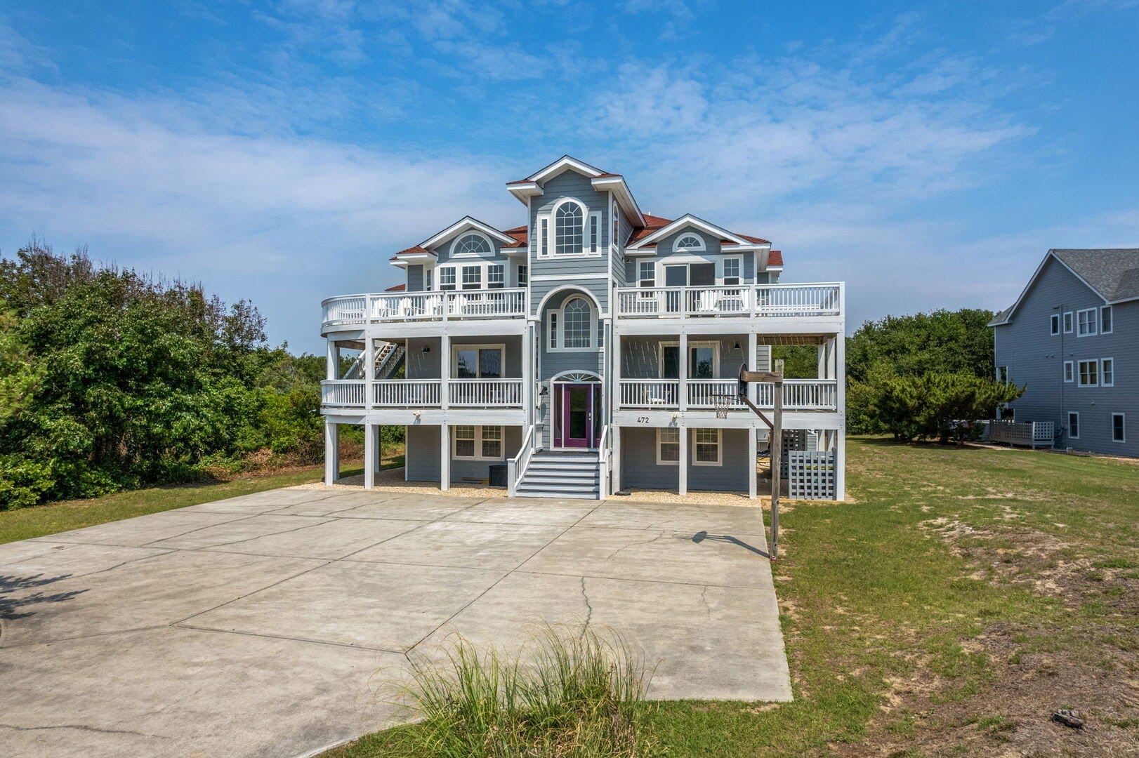 Large coastal house with balconies.