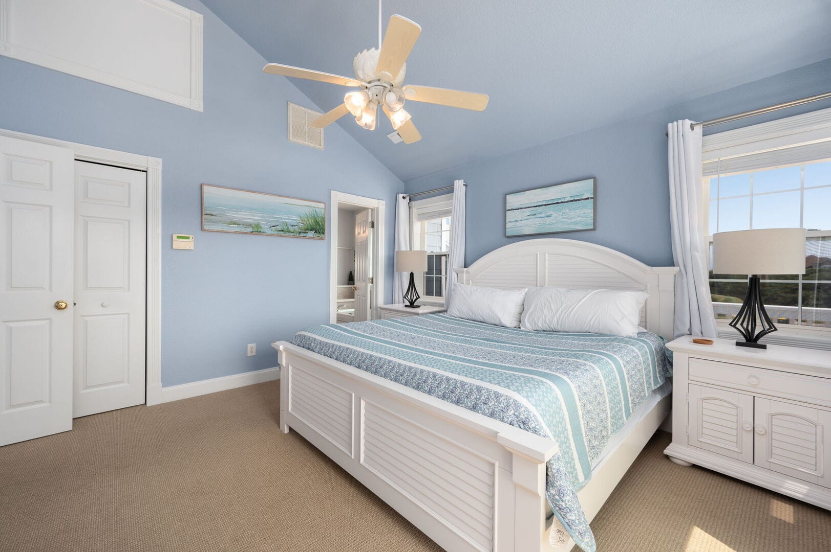 Blue bedroom with large bed.