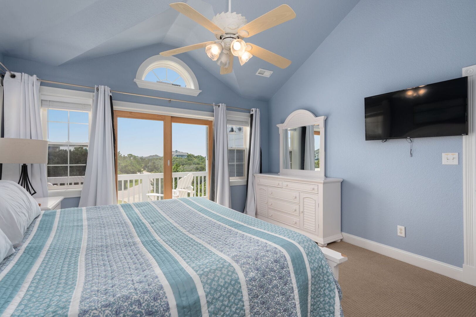 Cozy blue bedroom with balcony.