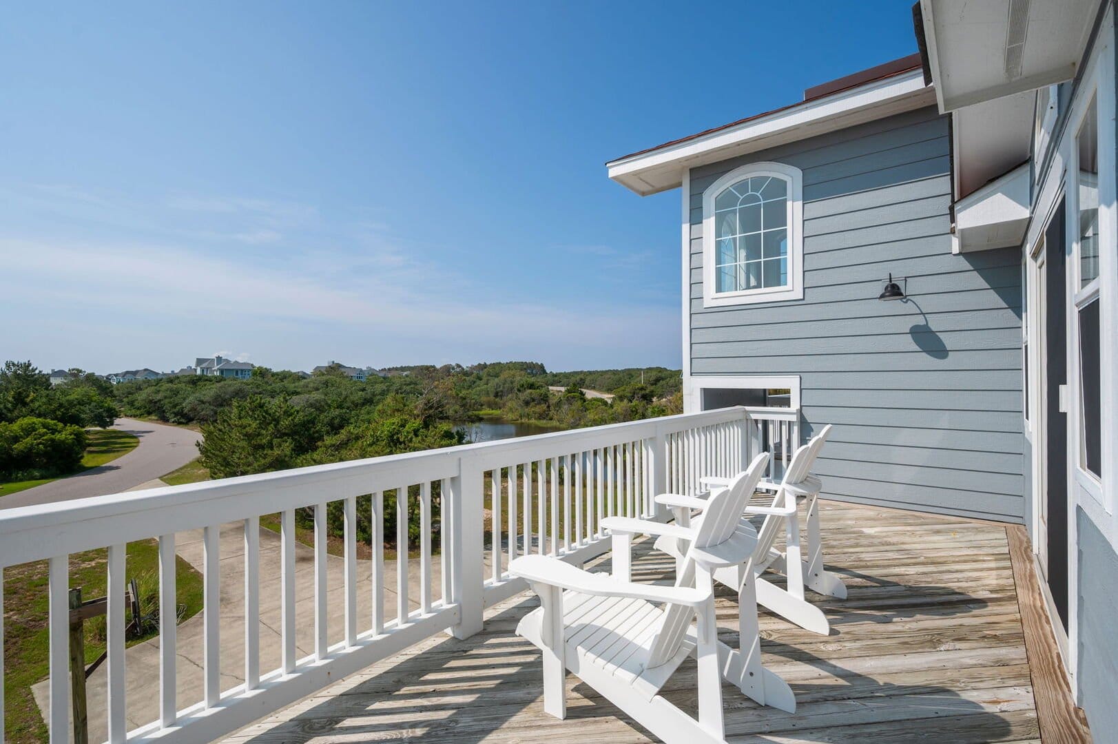 Deck chairs overlooking scenic landscape.