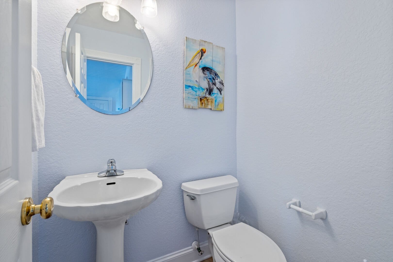 Bathroom with pelican wall art.