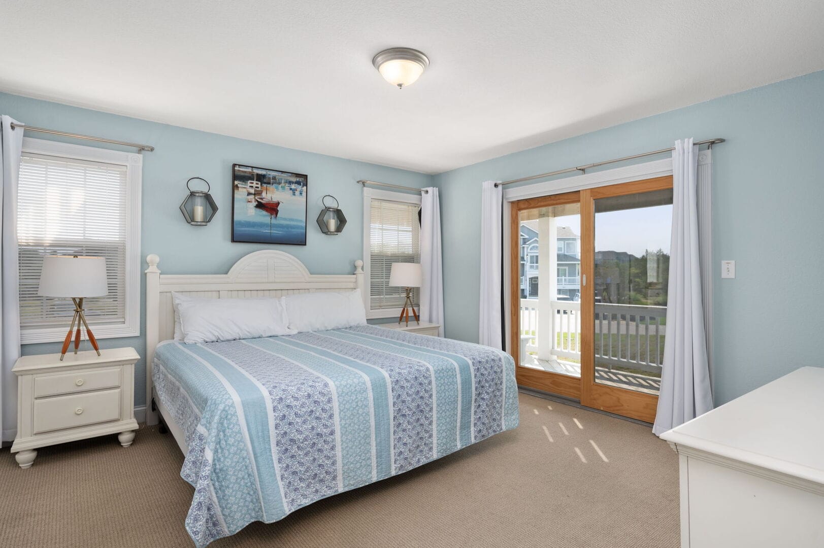 Bedroom with blue accents, balcony.