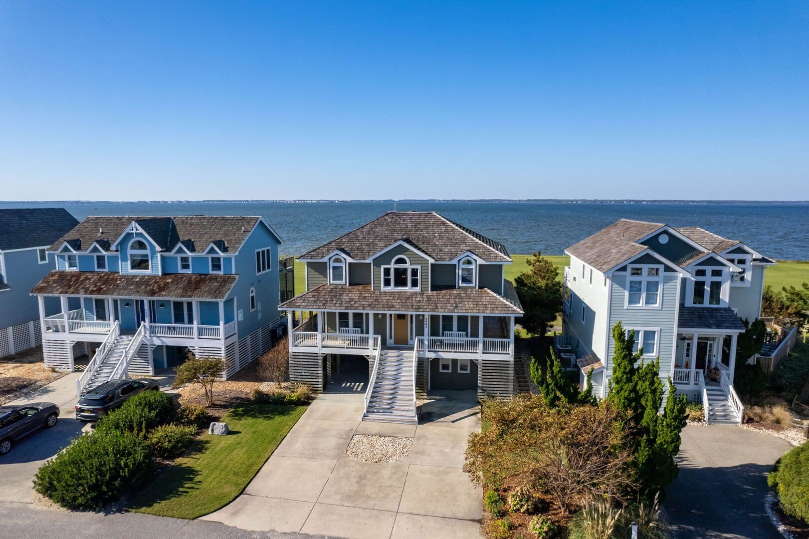 Three coastal houses by the water.
