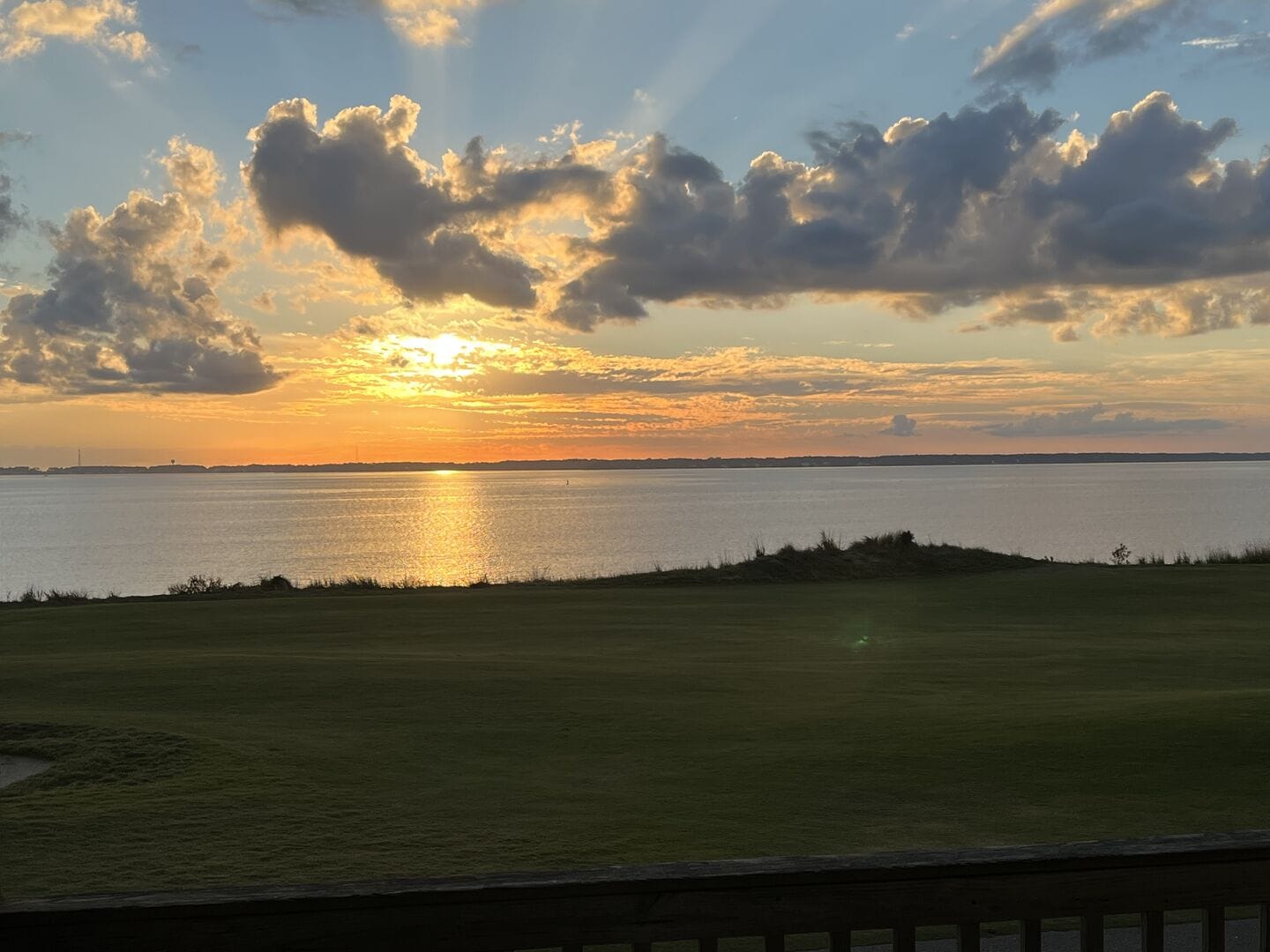 Sunset over lake with clouds.