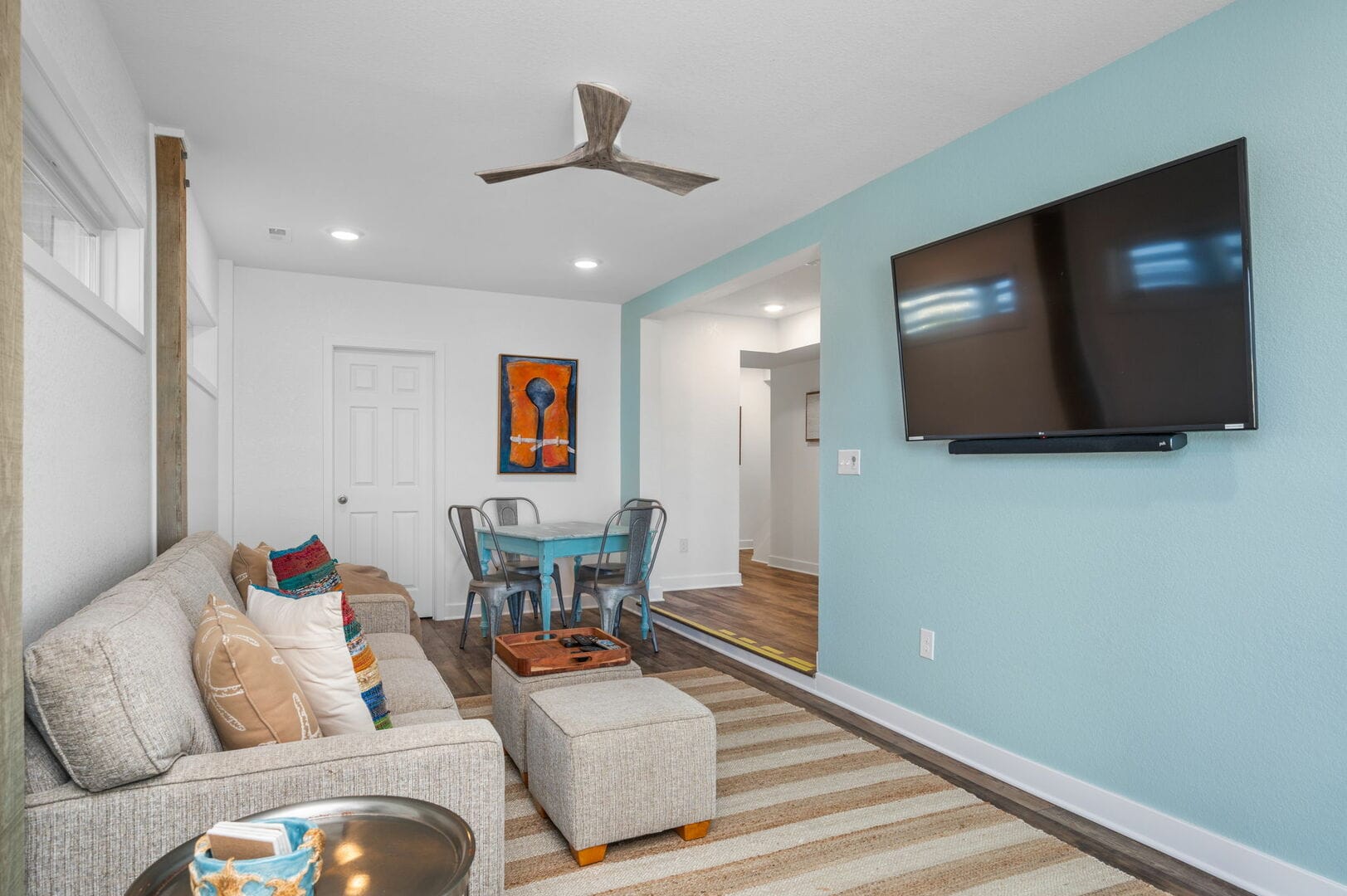 Modern living room with wall-mounted TV.