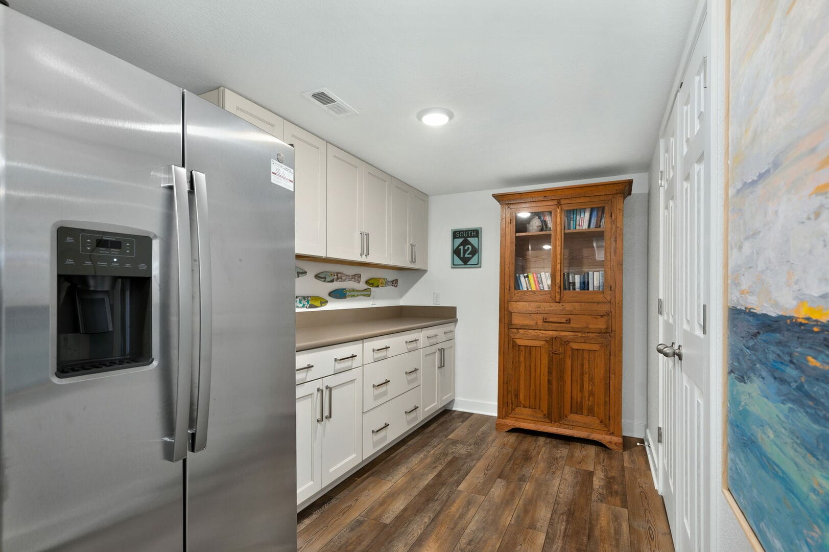 Kitchen with cabinets and refrigerator.