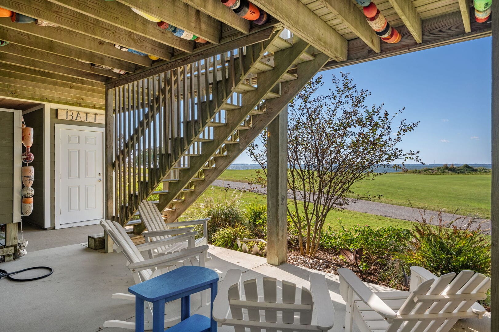 Porch with chairs overlooking lawn.
