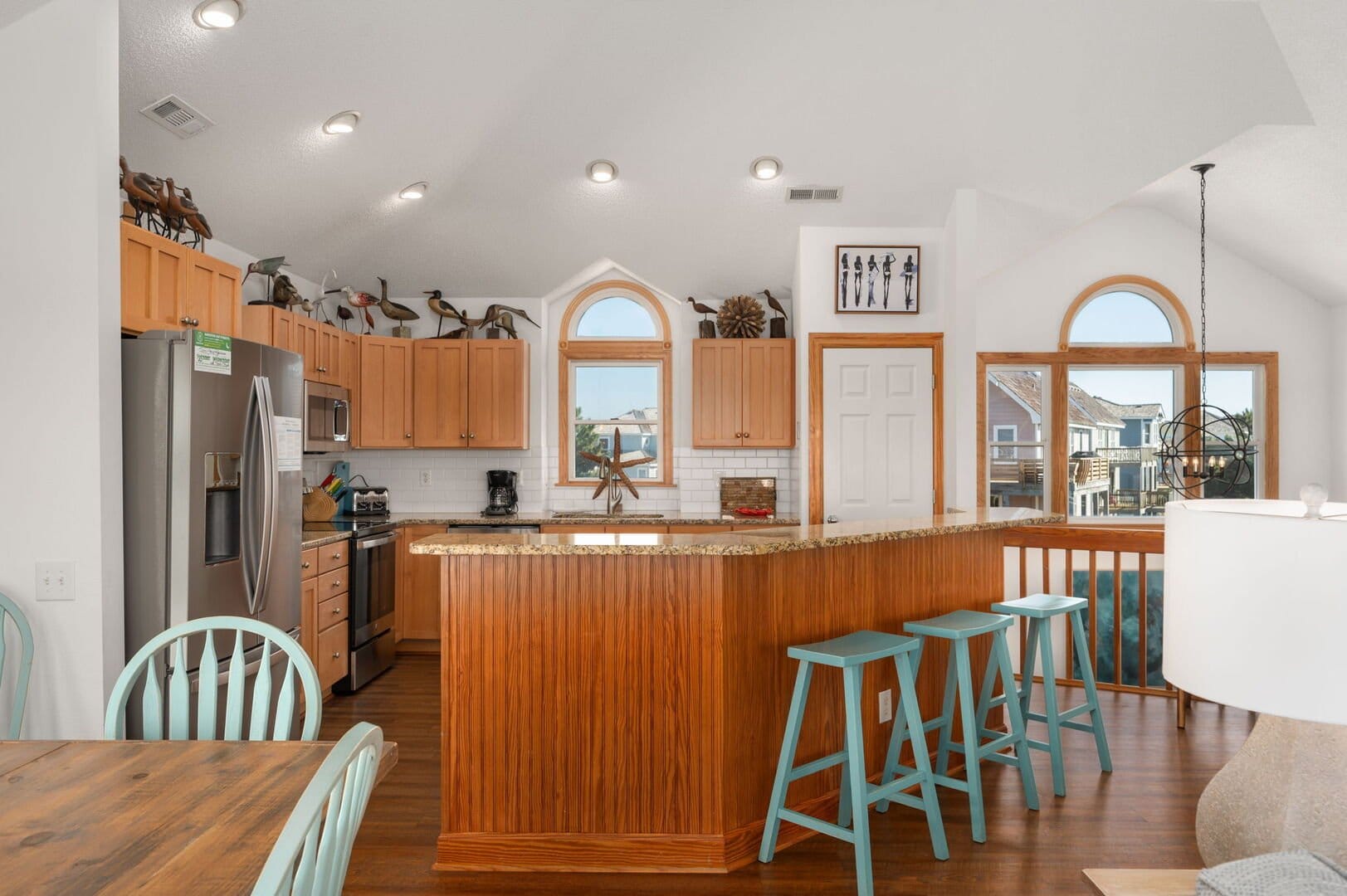 Spacious kitchen with bar stools.