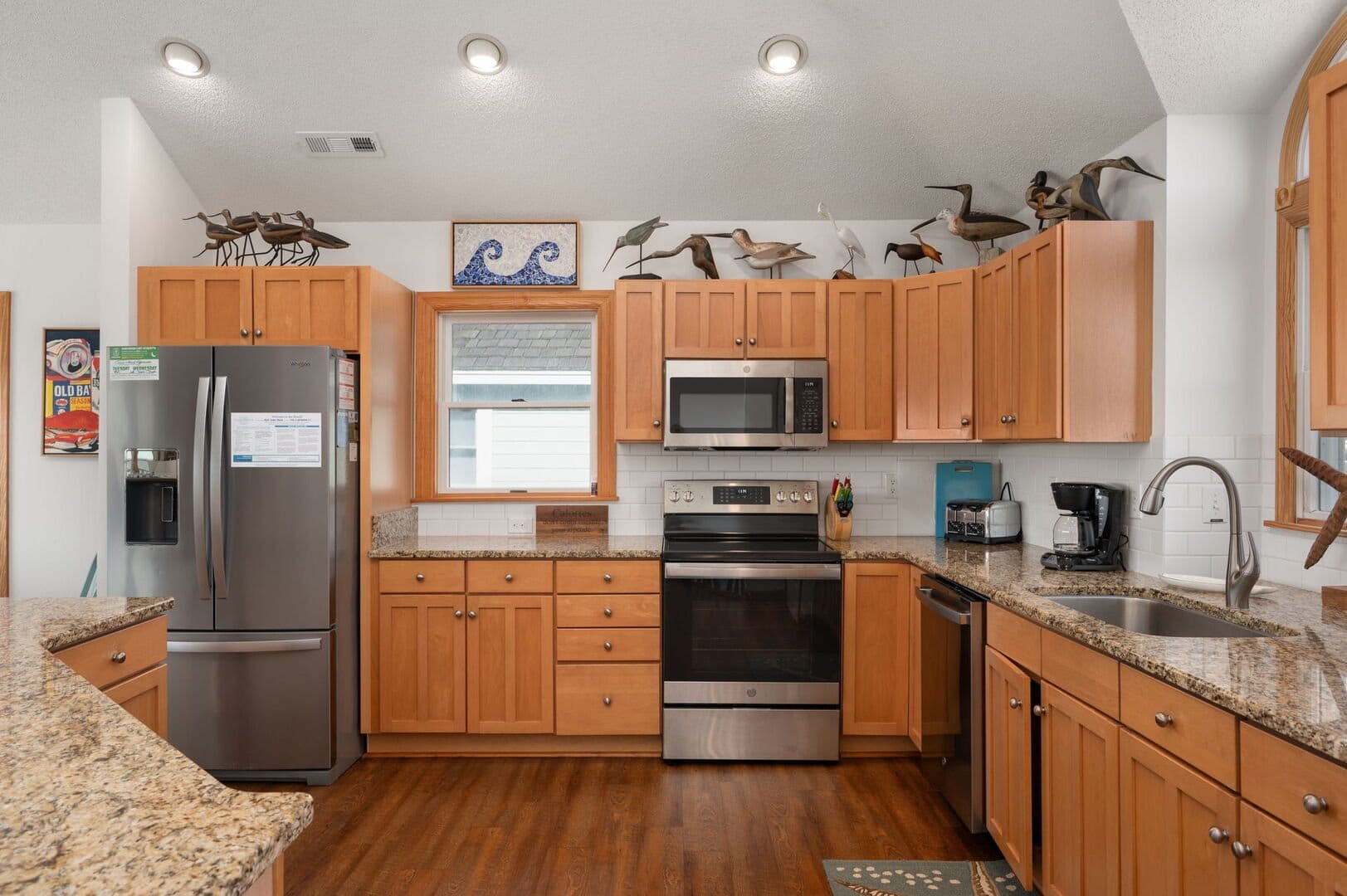 Wood kitchen with stainless steel appliances.
