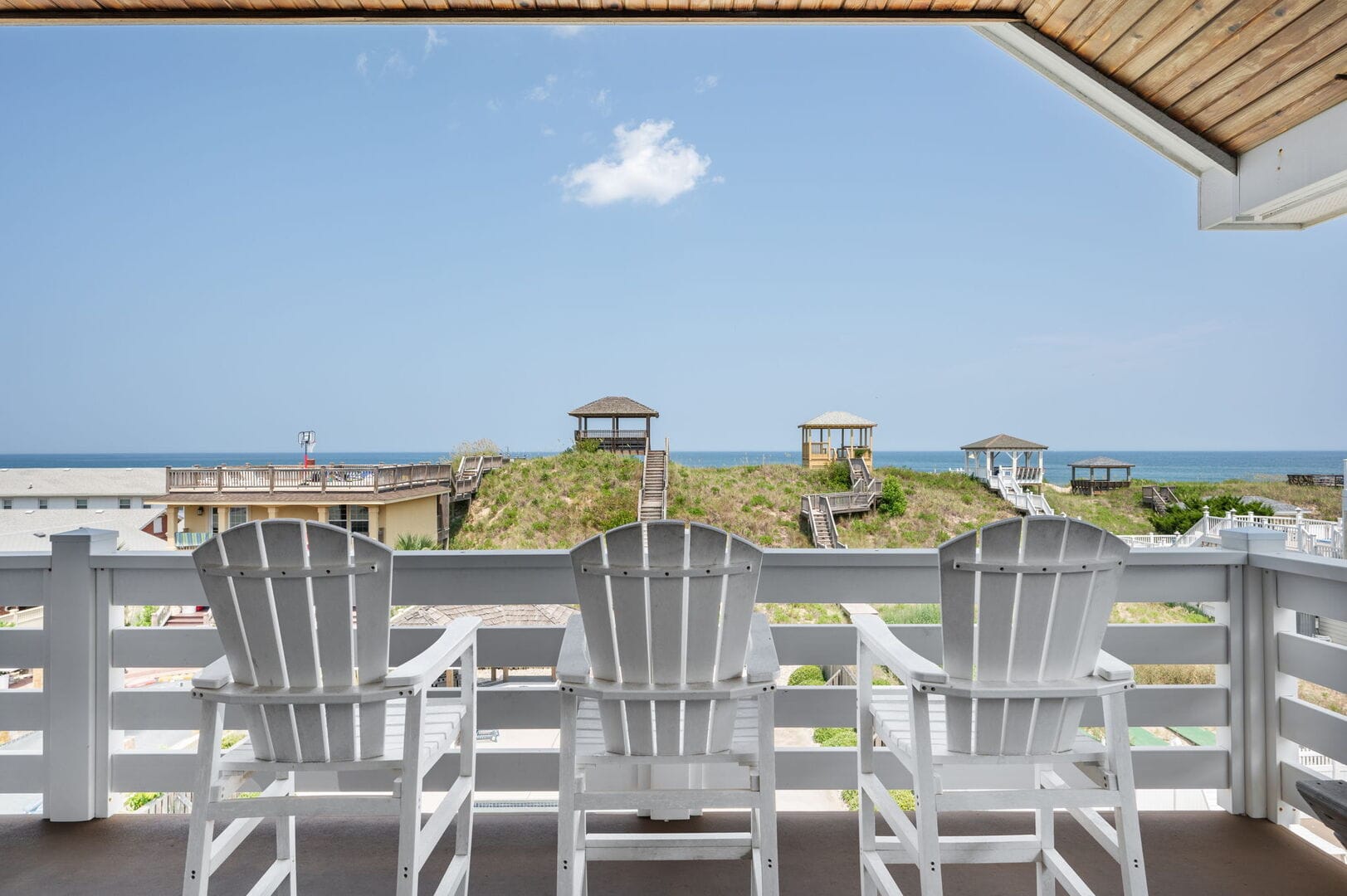 Three chairs facing ocean view.