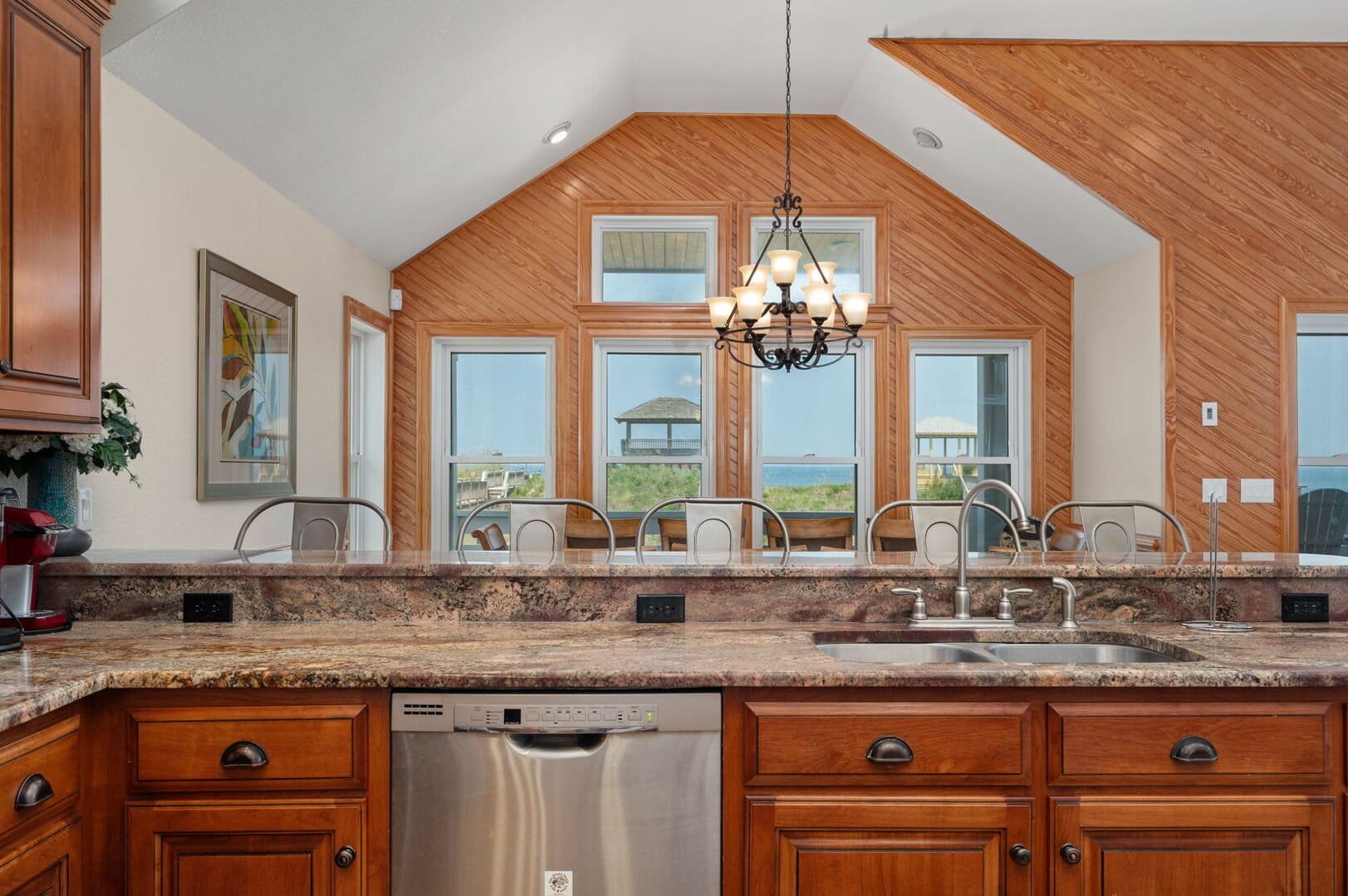Kitchen with wooden cabinets, windows.