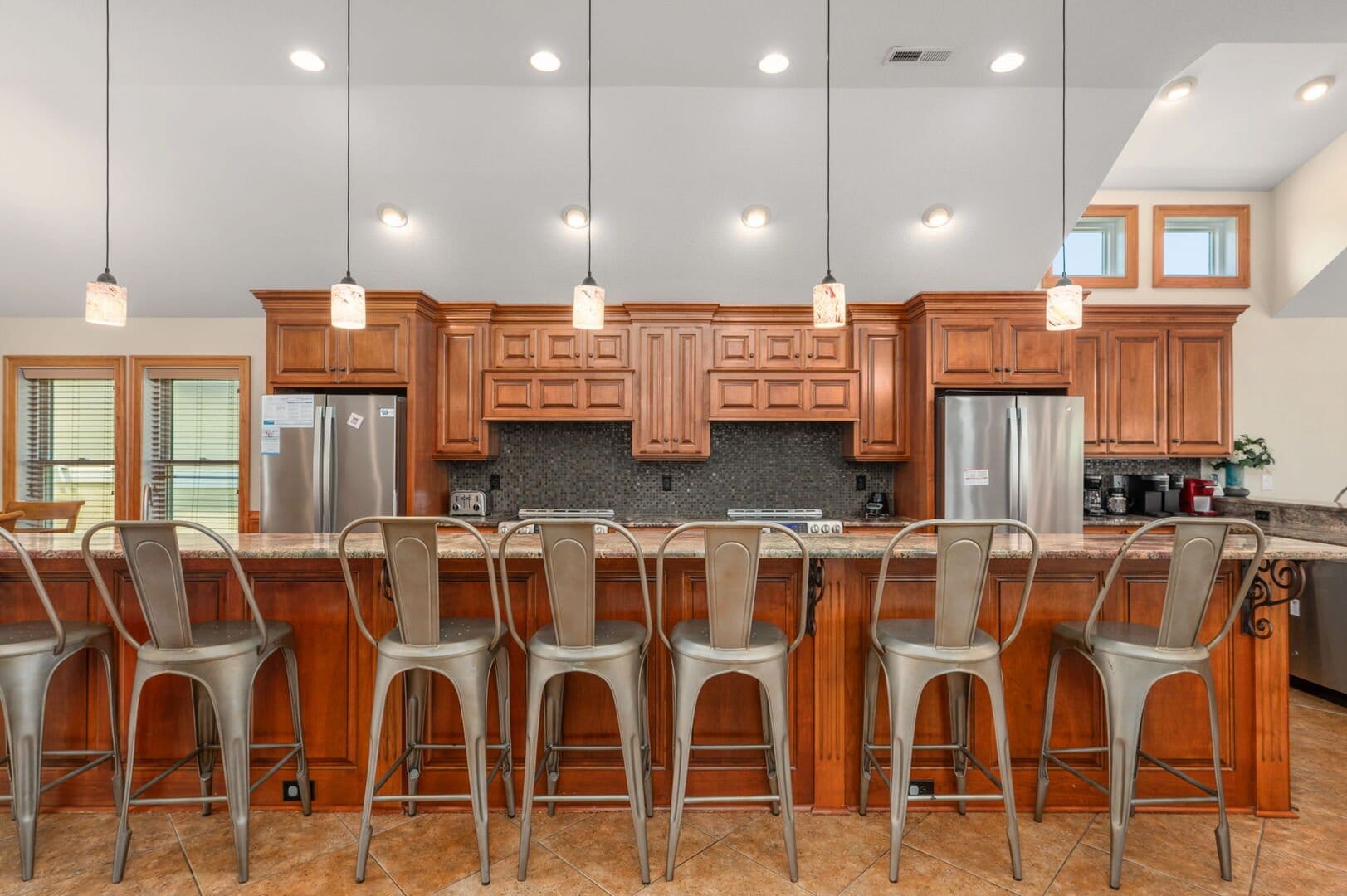 Barstools at a wooden kitchen counter.