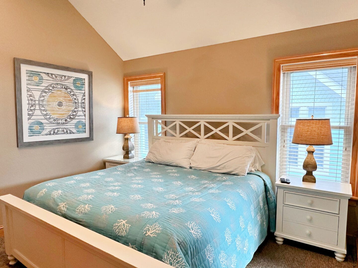 Cozy bedroom with patterned bedspread.